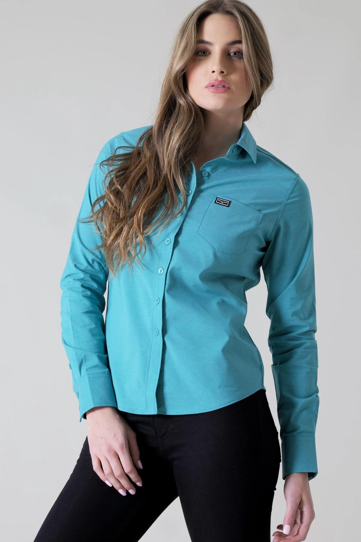 Kimes Ranch Ladies Linville Teal long sleeve button-up top with a chest pocket and logo patch