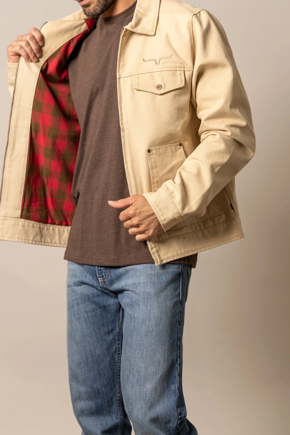 Kimes Ranch Logan Jacket in Tan, side view, with red and green plaid lining and chest pocket