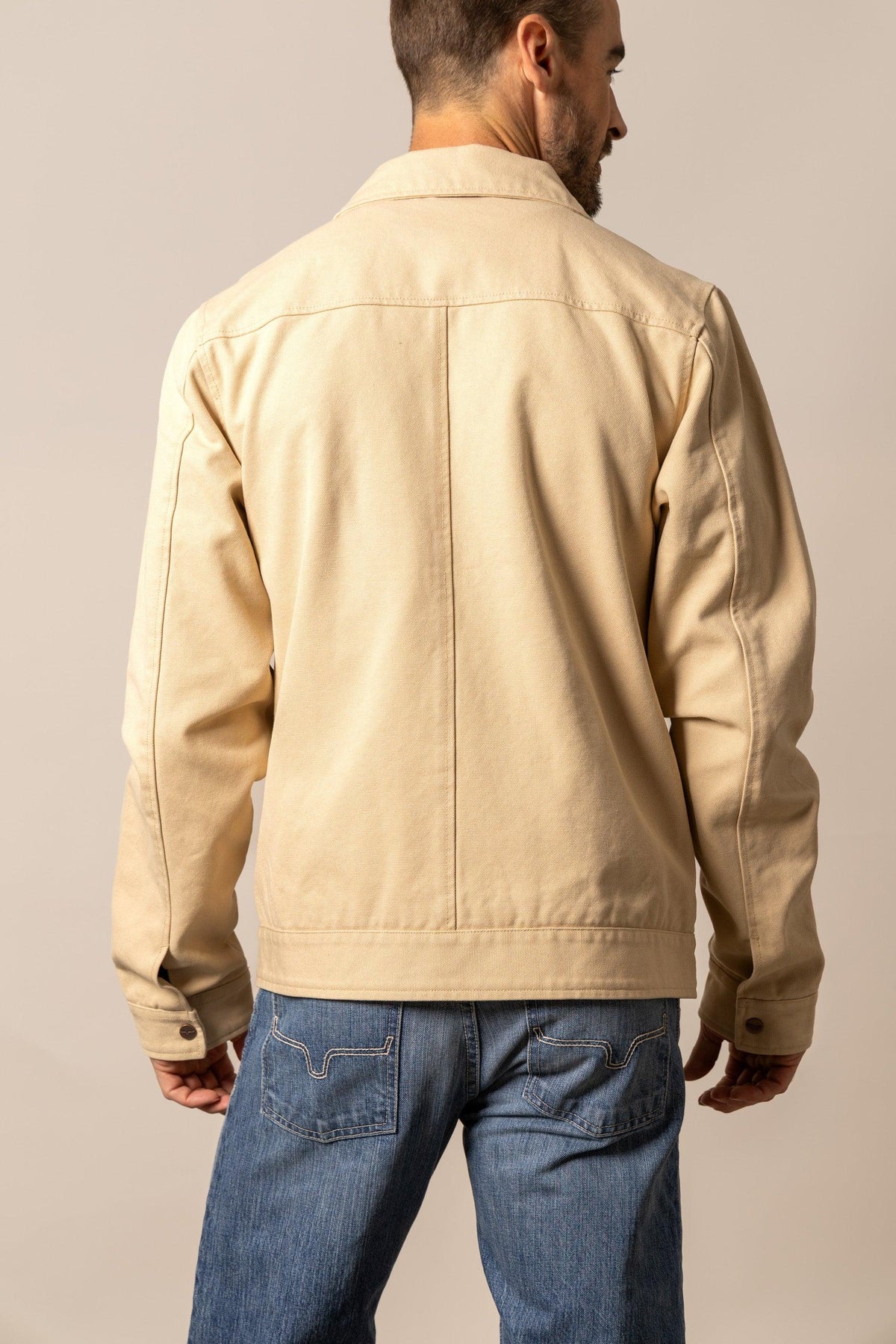Kimes Ranch Logan Jacket in Tan, back view, with a back yoke and buttoned cuffs