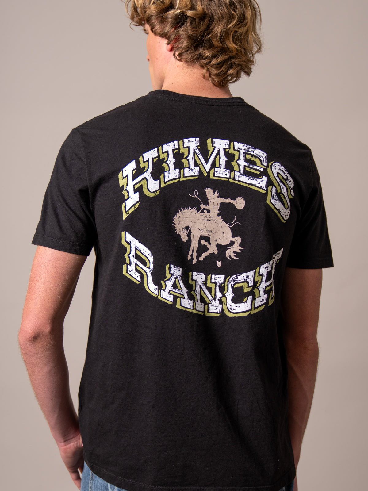 Kimes Ranch Lucky B Bucking shirt in Black, back view, with a back graphic of a cowboy riding a bucking horse