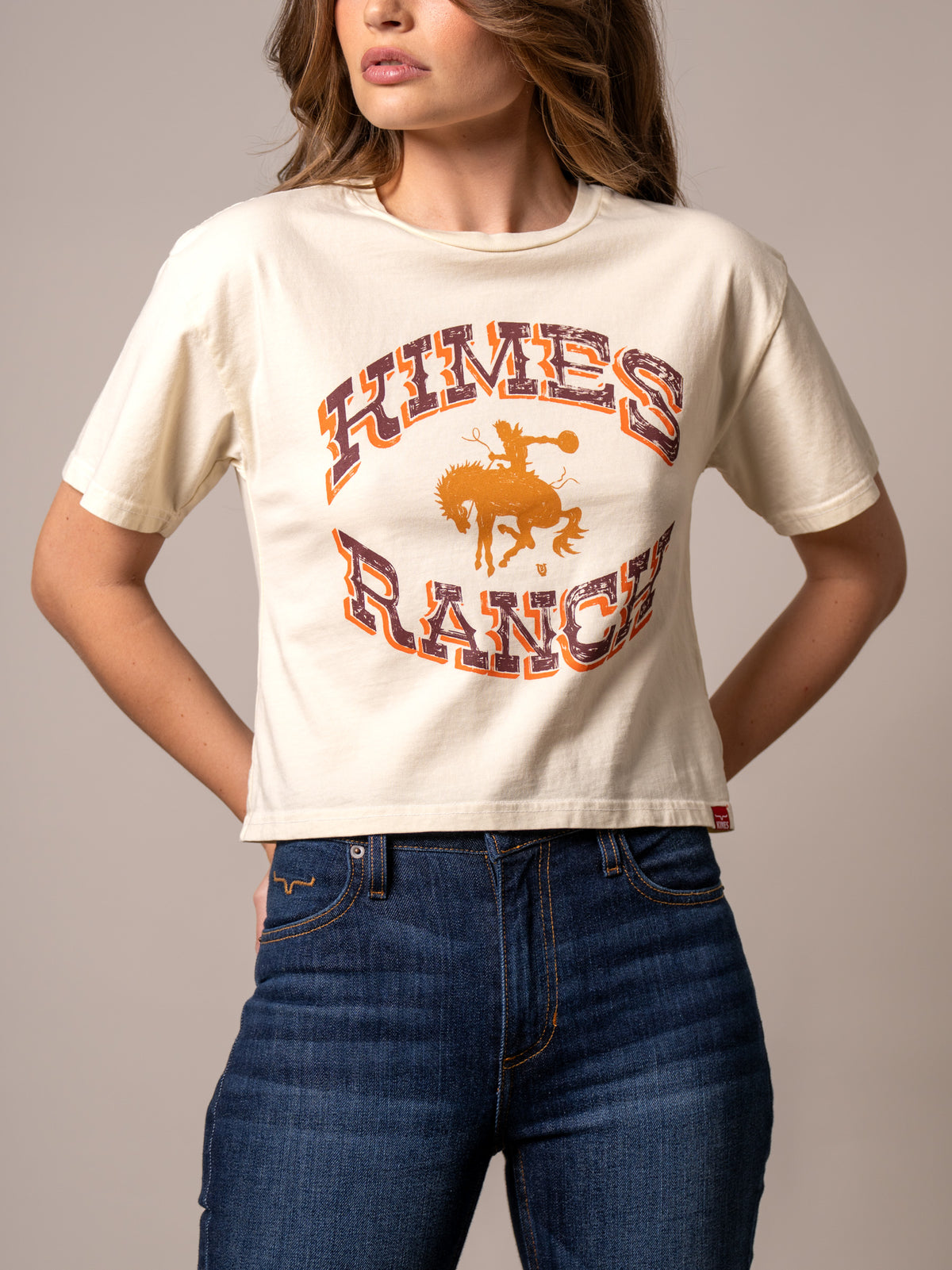 Kimes Ranch Lucky B Bucking shirt in Ivory with a graphic of a cowboy on a bucking horse and the words Kimes Ranch