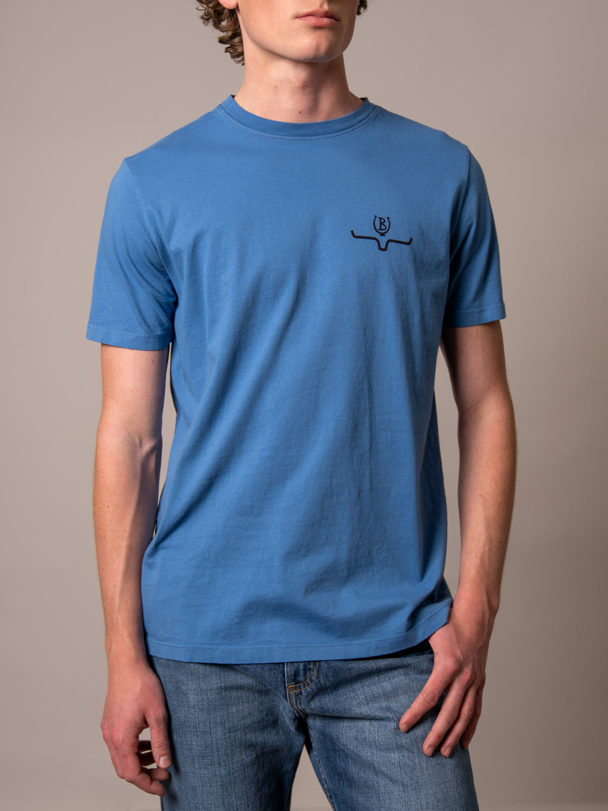 Kimes Ranch Lucky B Bucking shirt in Mid Blue with a short sleeve crew neck and the Kimes Ranch logo on the chest