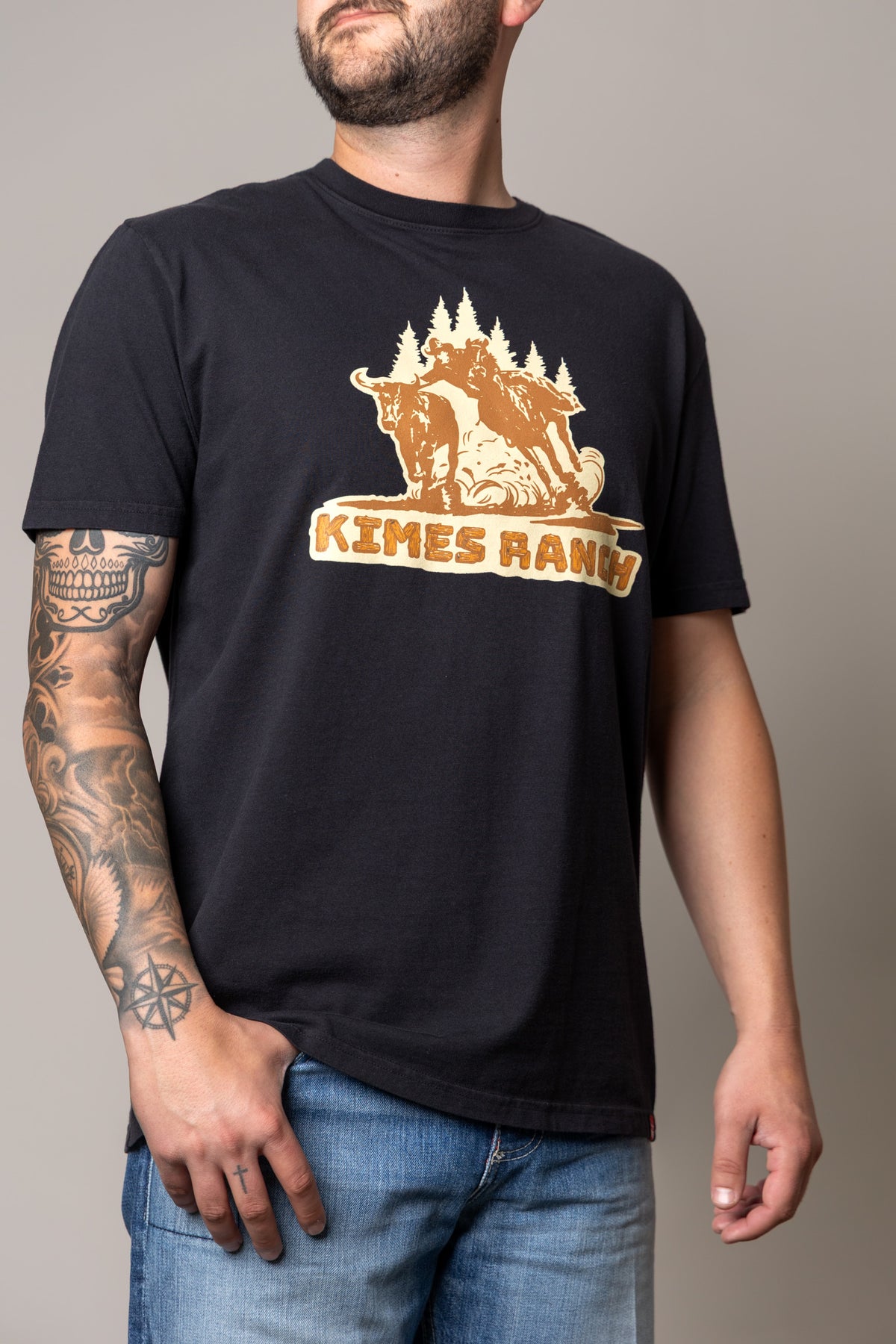 Kimes Ranch Lucky B Bull Dogger shirt in Black with a graphic of a bull rider and trees and the words KIMES RANCH