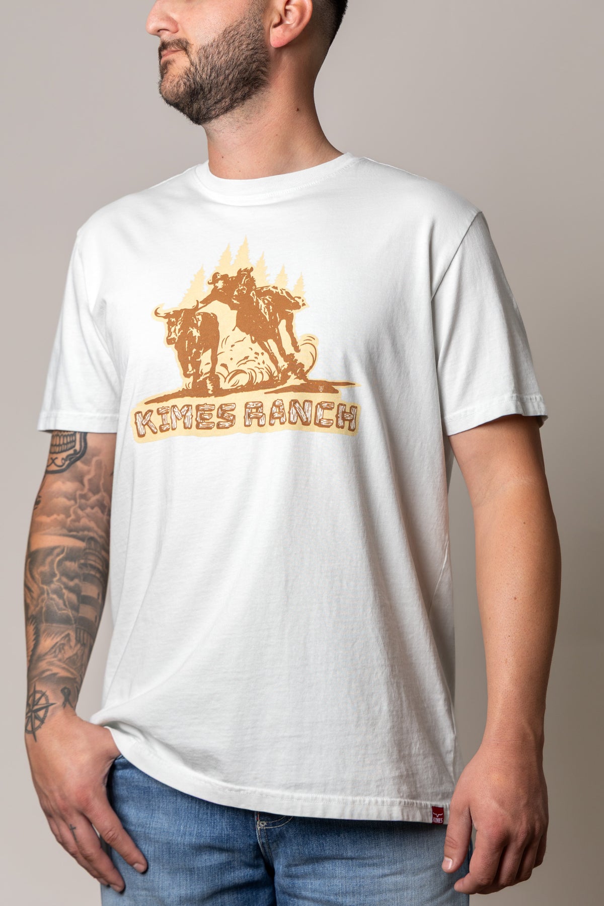 Kimes Ranch Lucky B Bull Dogger shirt in Muted White with a graphic of a cowboy on a bucking bull and the Kimes Ranch logo