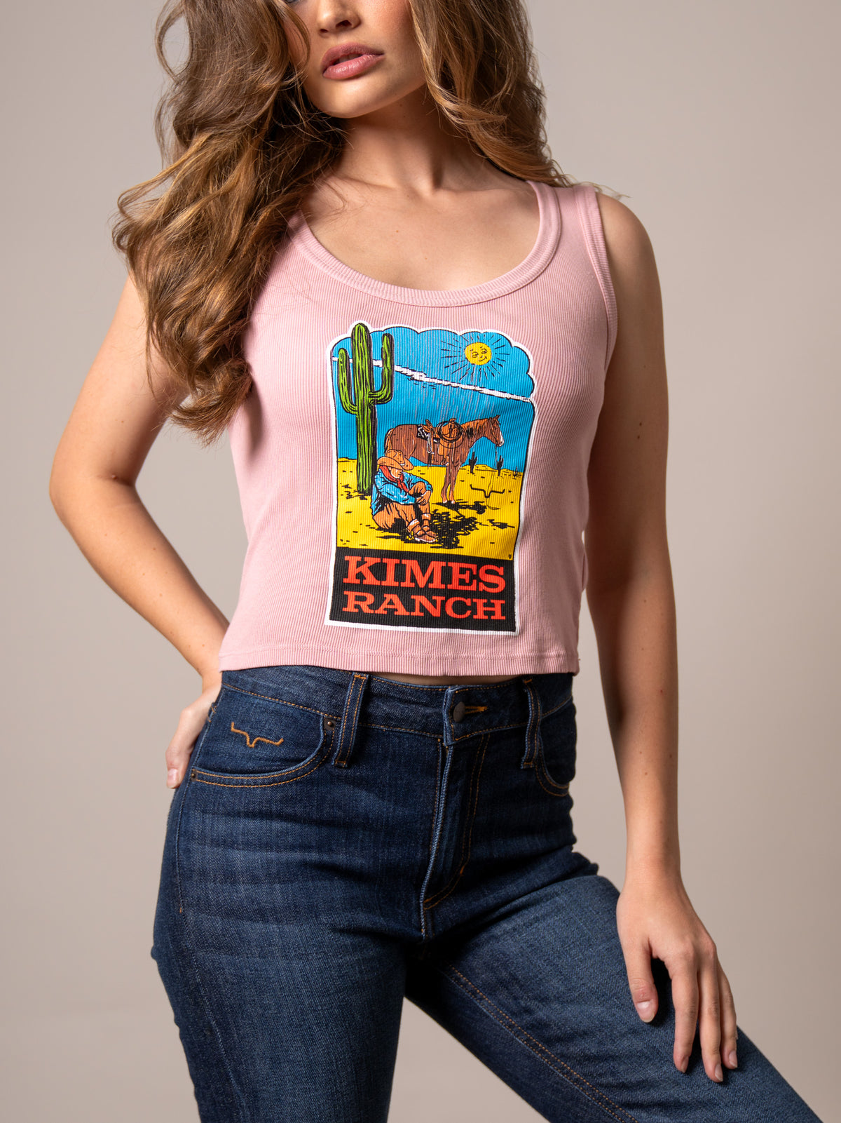 Kimes Ranch Lucky B Dusty Path Light Pink ribbed tank top with a graphic of a cowboy and horse with Kimes Ranch logo