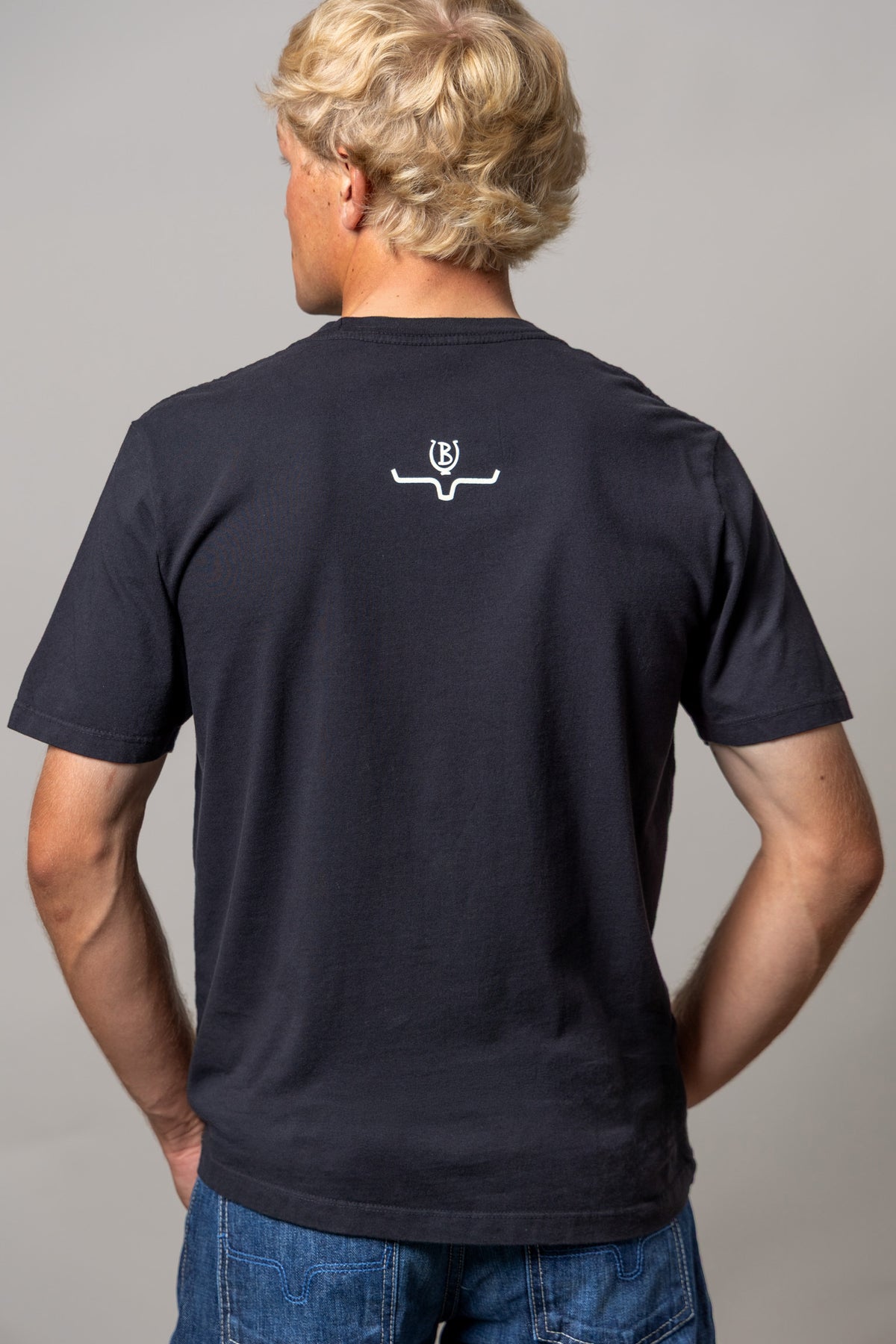 Kimes Ranch Lucky B Greetings shirt in Black, back view, with a white Kimes Ranch logo at the back yoke
