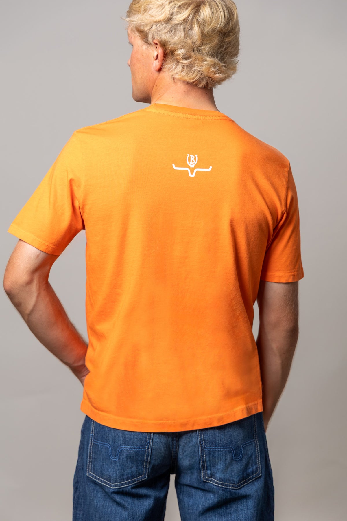 Kimes Ranch Lucky B Greetings shirt in Vintage Orange, back view, with the Kimes Ranch logo on the back