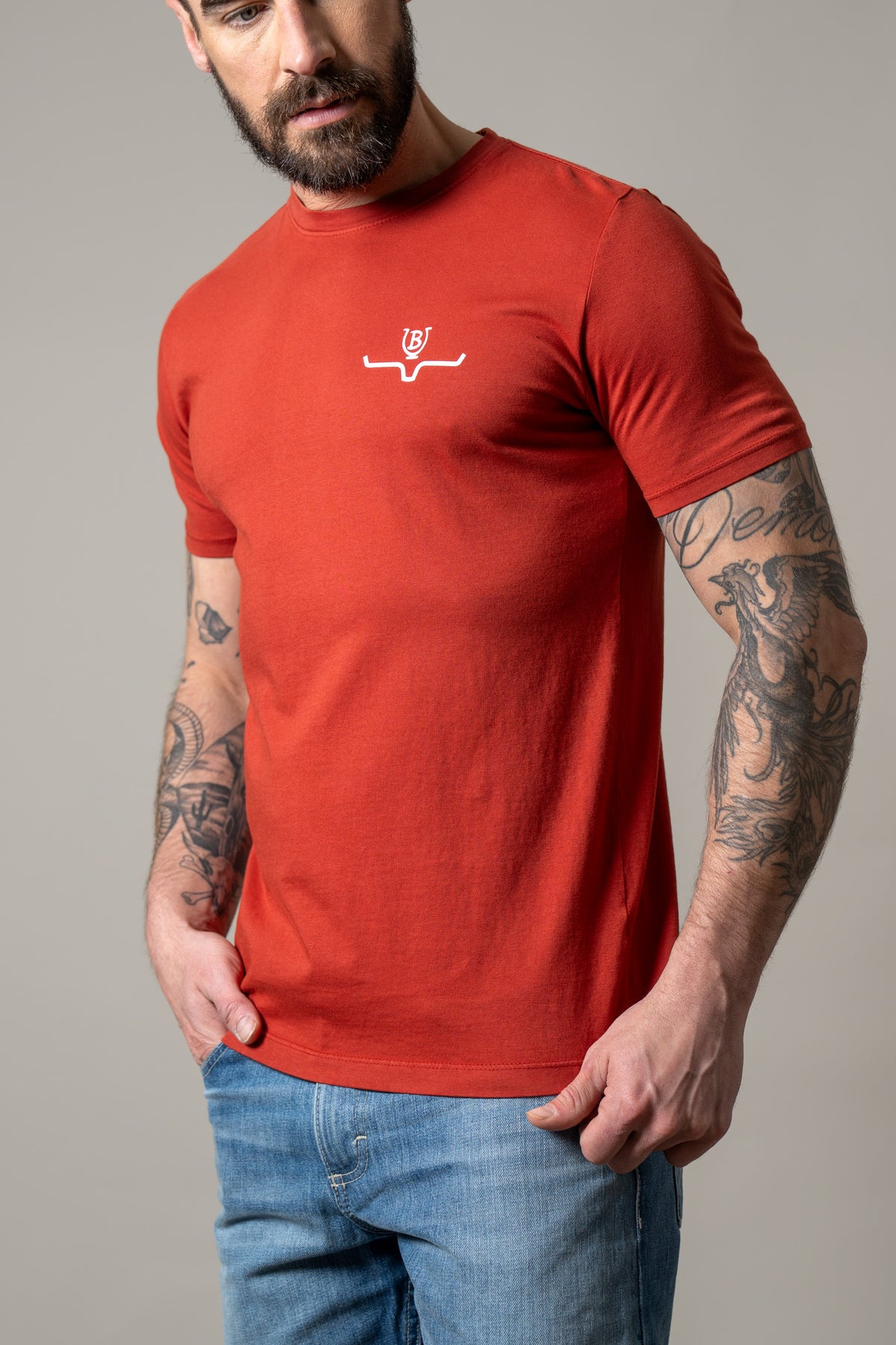Kimes Ranch Lucky B Iron shirt in Brick Red with a crew neck and short sleeves and a white logo on the chest