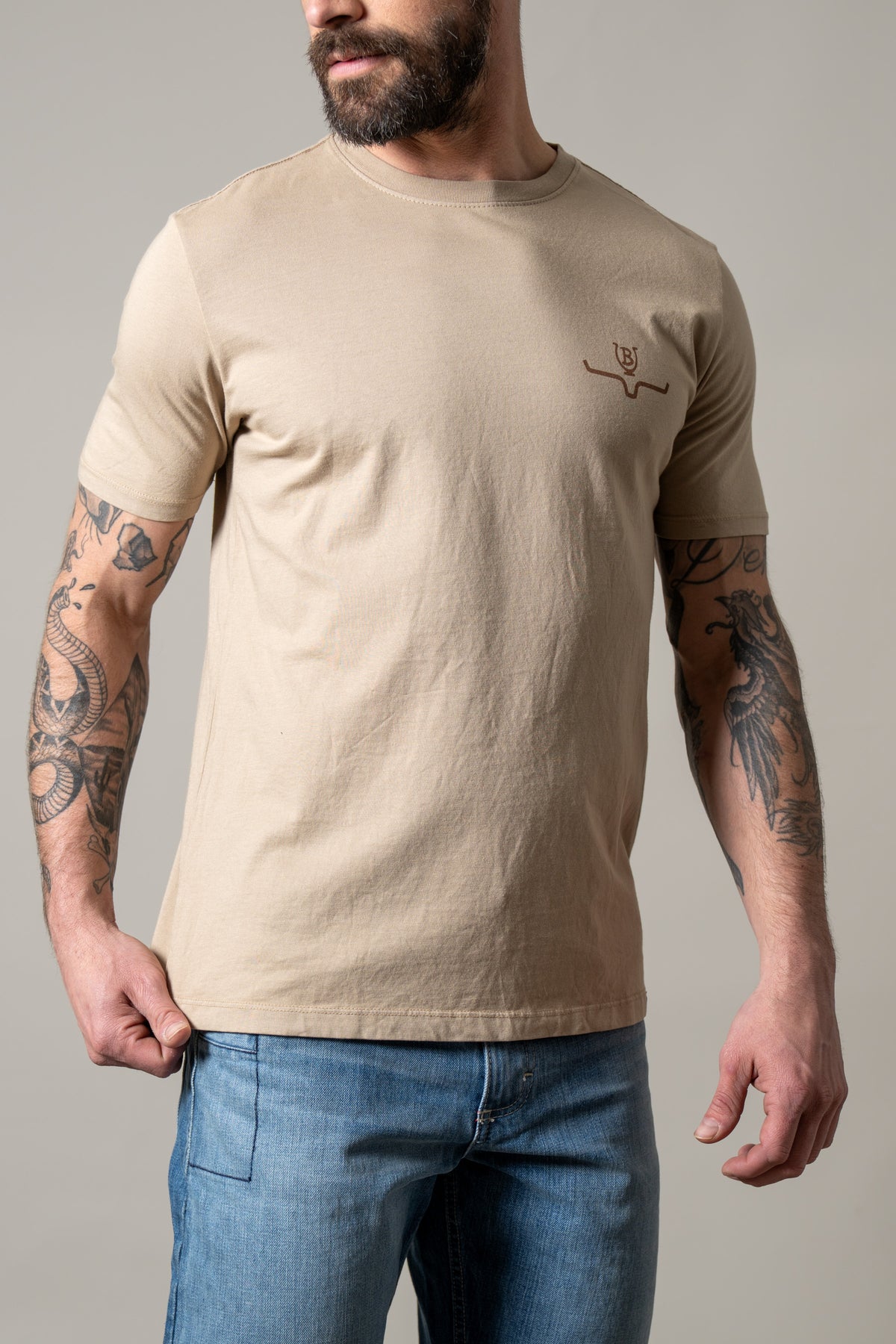 Kimes Ranch Lucky B Iron shirt in Sand with short sleeves and a crew neck featuring the Kimes Ranch logo on the chest