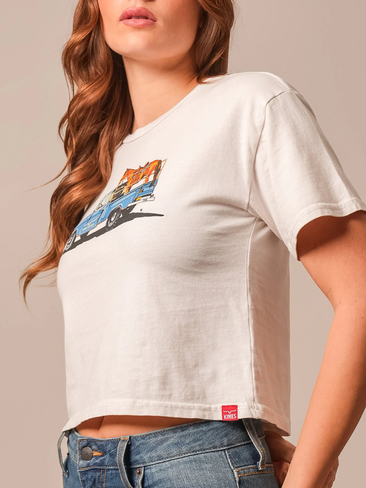 Kimes Ranch Lucky B Pick Up shirt in Bone, side view, with a blue and orange truck graphic and a red Kimes Ranch logo tag