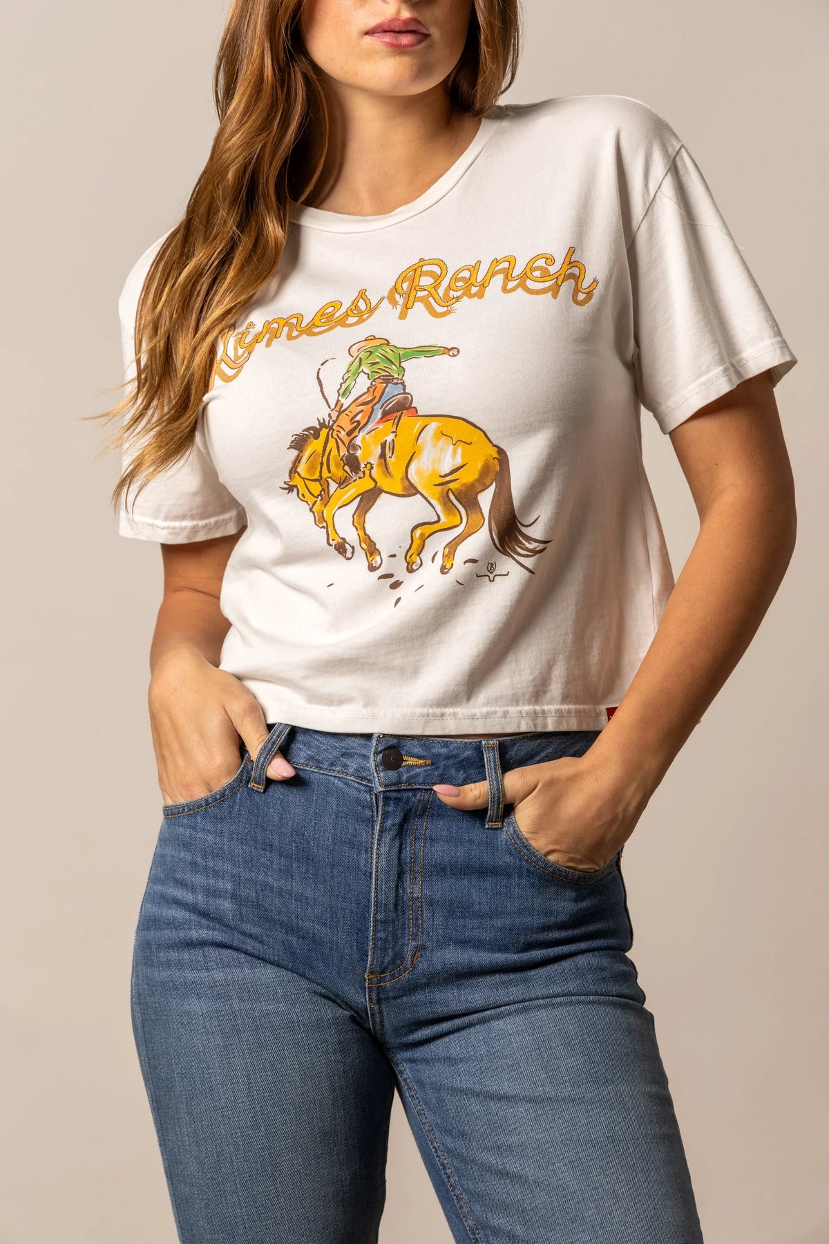 Kimes Ranch Lucky B Rodee-oh! shirt in Bone with a graphic of a cowboy riding a bucking horse and the words Kimes Ranch