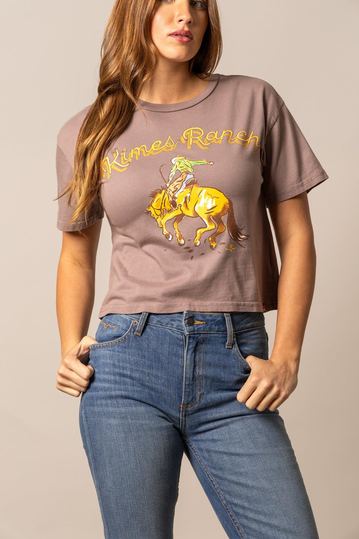 Kimes Ranch Lucky B Rodee-oh! Mocha short sleeve shirt with a graphic of a cowboy riding a bucking horse and Kimes Ranch logo