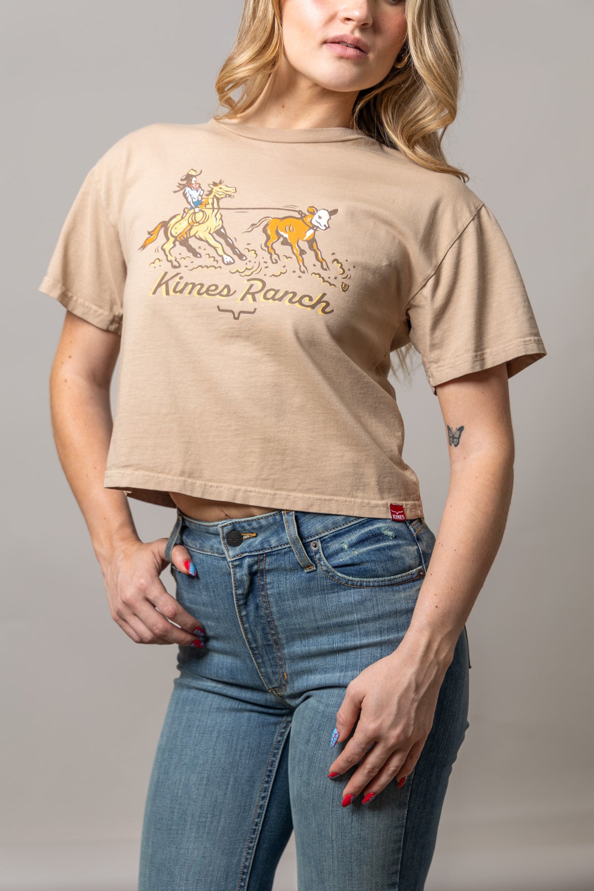 Kimes Ranch Lucky B Roper shirt in Tan with a graphic of a rodeo rider roping a calf and the Kimes Ranch logo