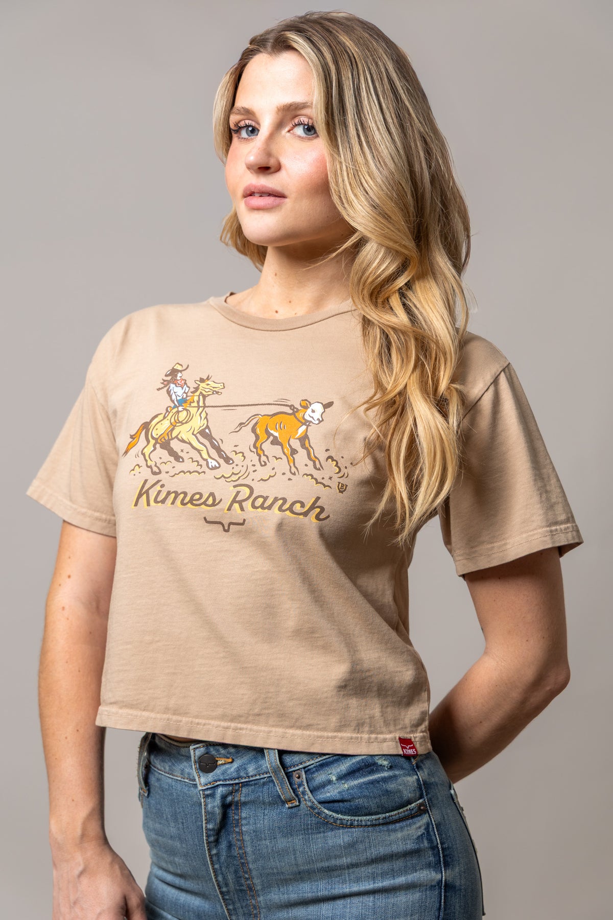 Kimes Ranch Lucky B Roper shirt in Tan with a graphic of a cowgirl roping a calf and the words Kimes Ranch
