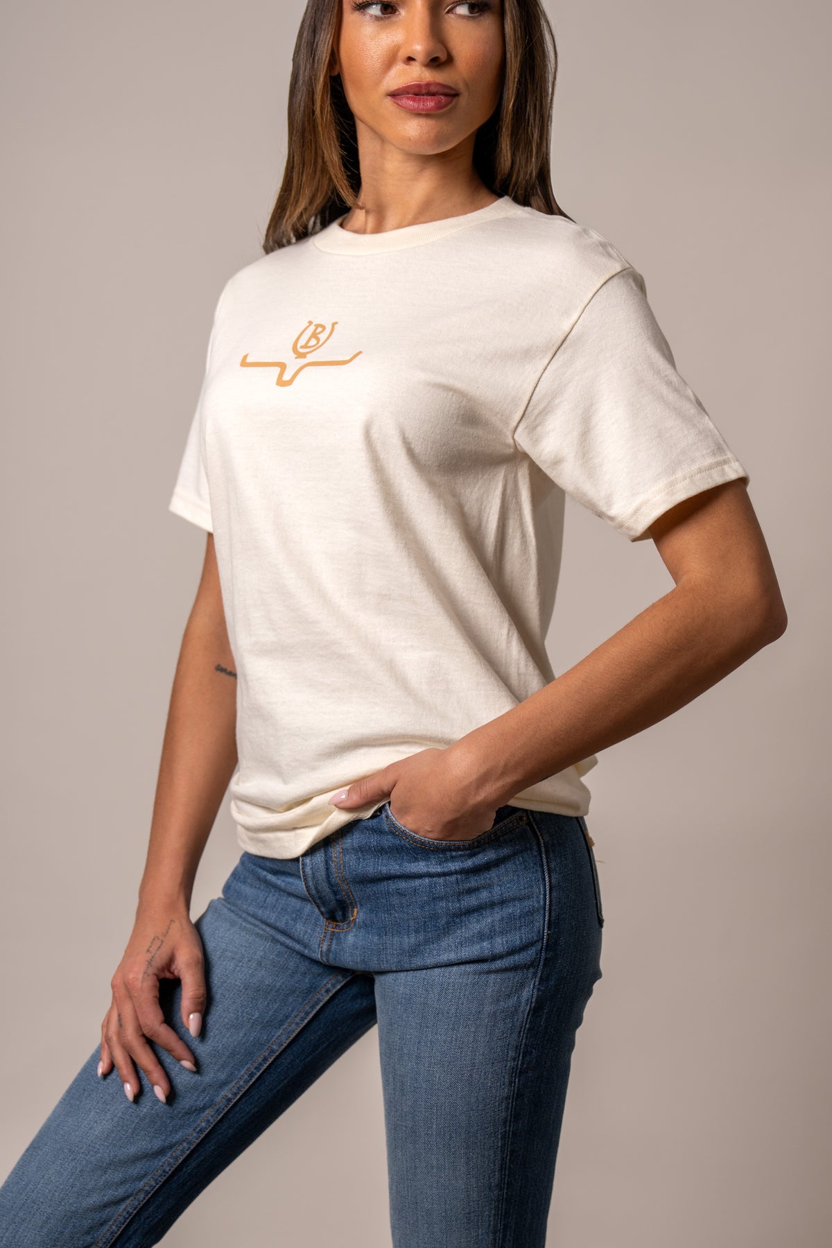 Kimes Ranch Lucky B Saddle shirt in cream with a short sleeve crew neck and a small embroidered logo on the chest