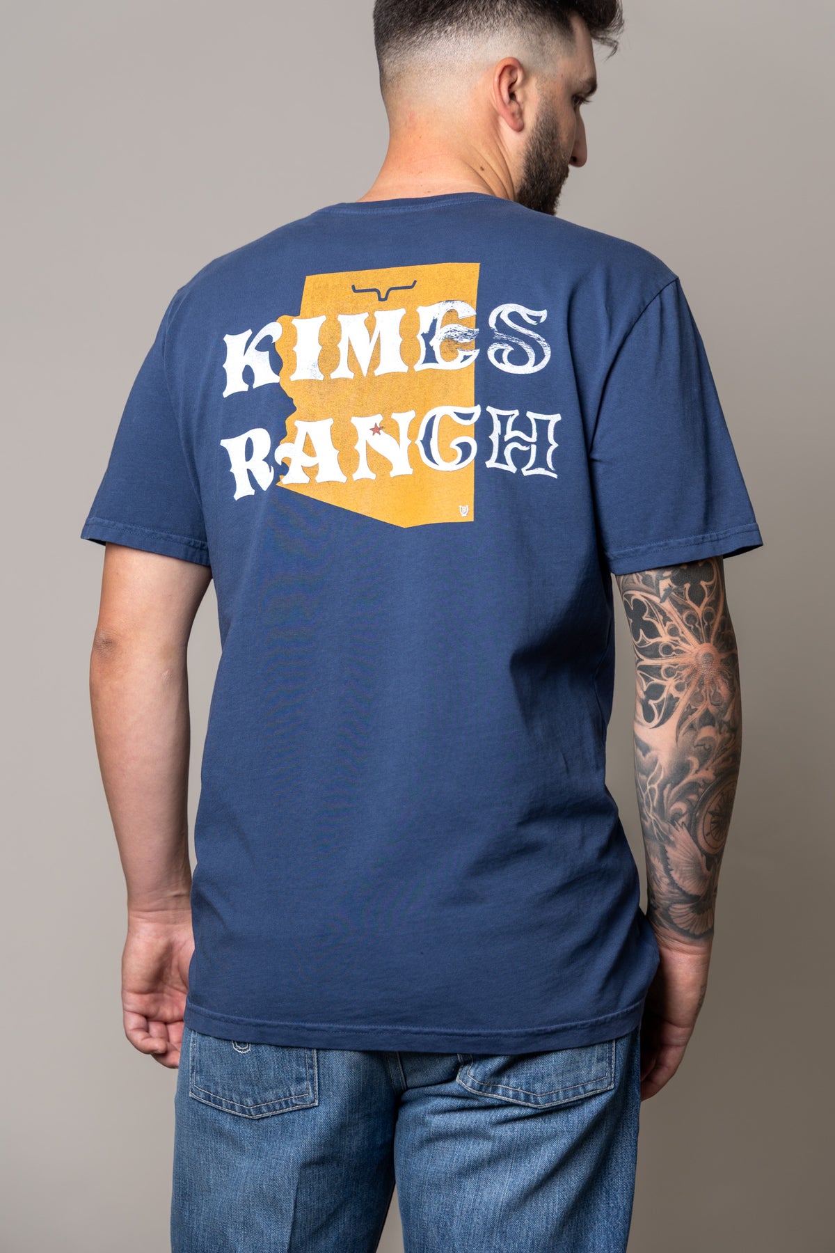Kimes Ranch Lucky B Statewide shirt in Indigo, back view, with a back graphic of a yellow state outline
