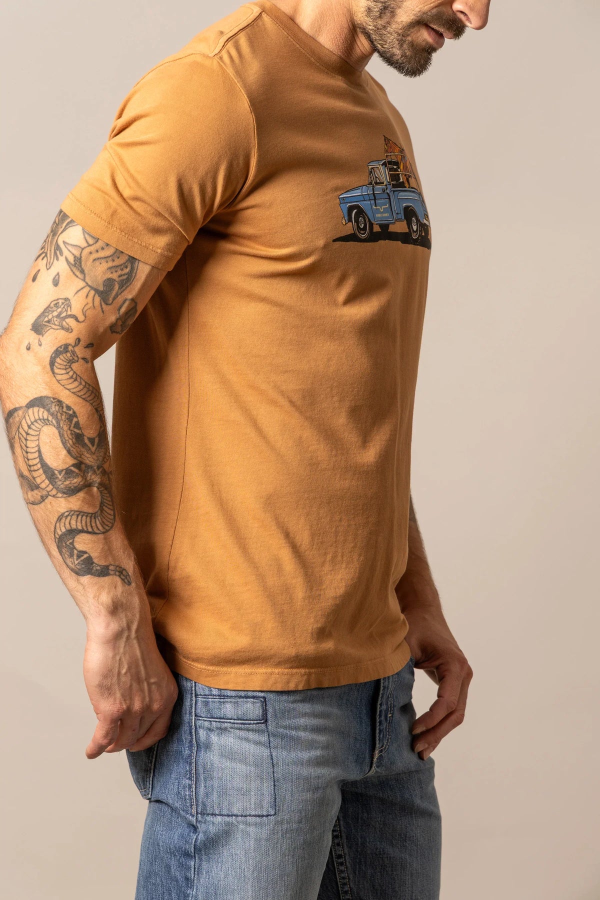 Kimes Ranch Lucky B Truck shirt in Work Wear Brown, side view, with a blue truck graphic on the chest
