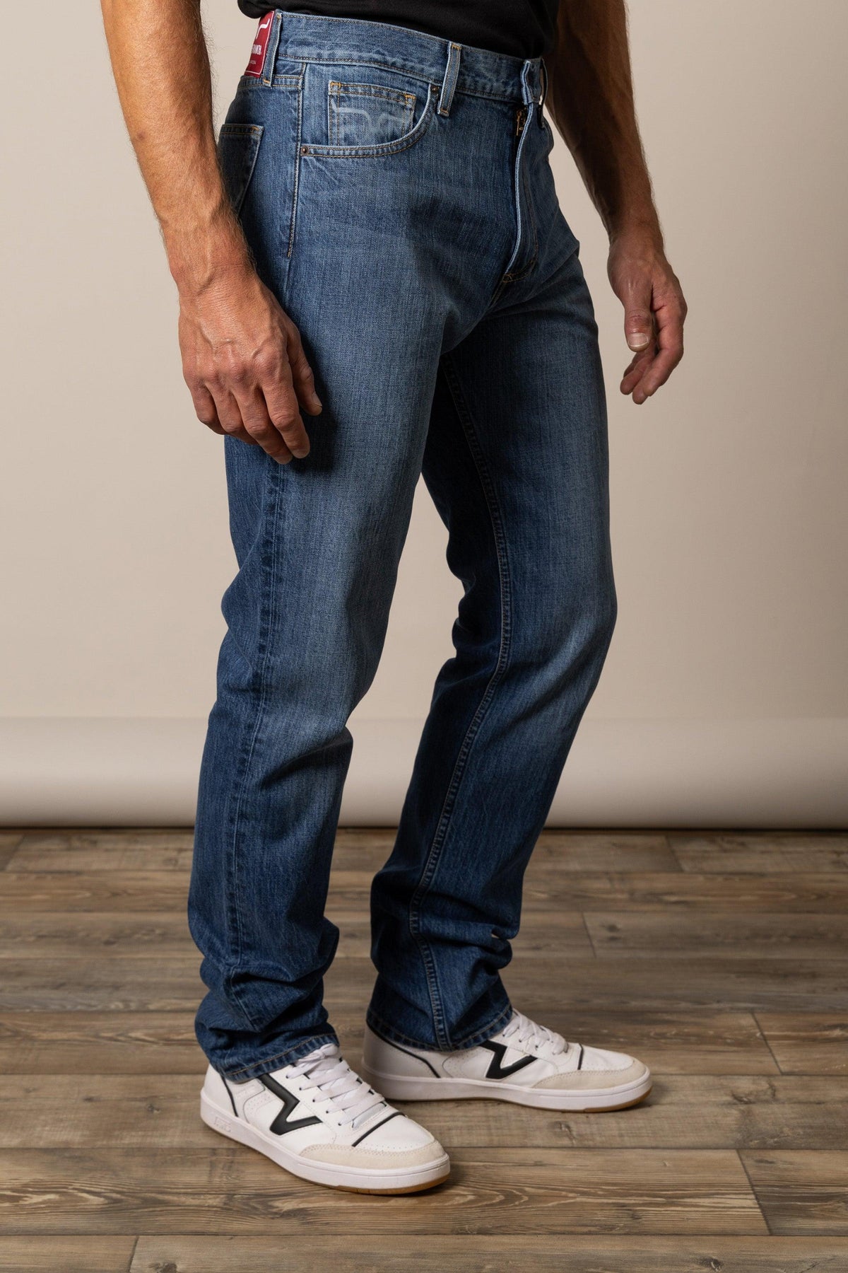 Kimes Ranch Luke Mid Wash Slim Fit jeans in Mid Wash, side view, blue with a slim fit silhouette and front pockets