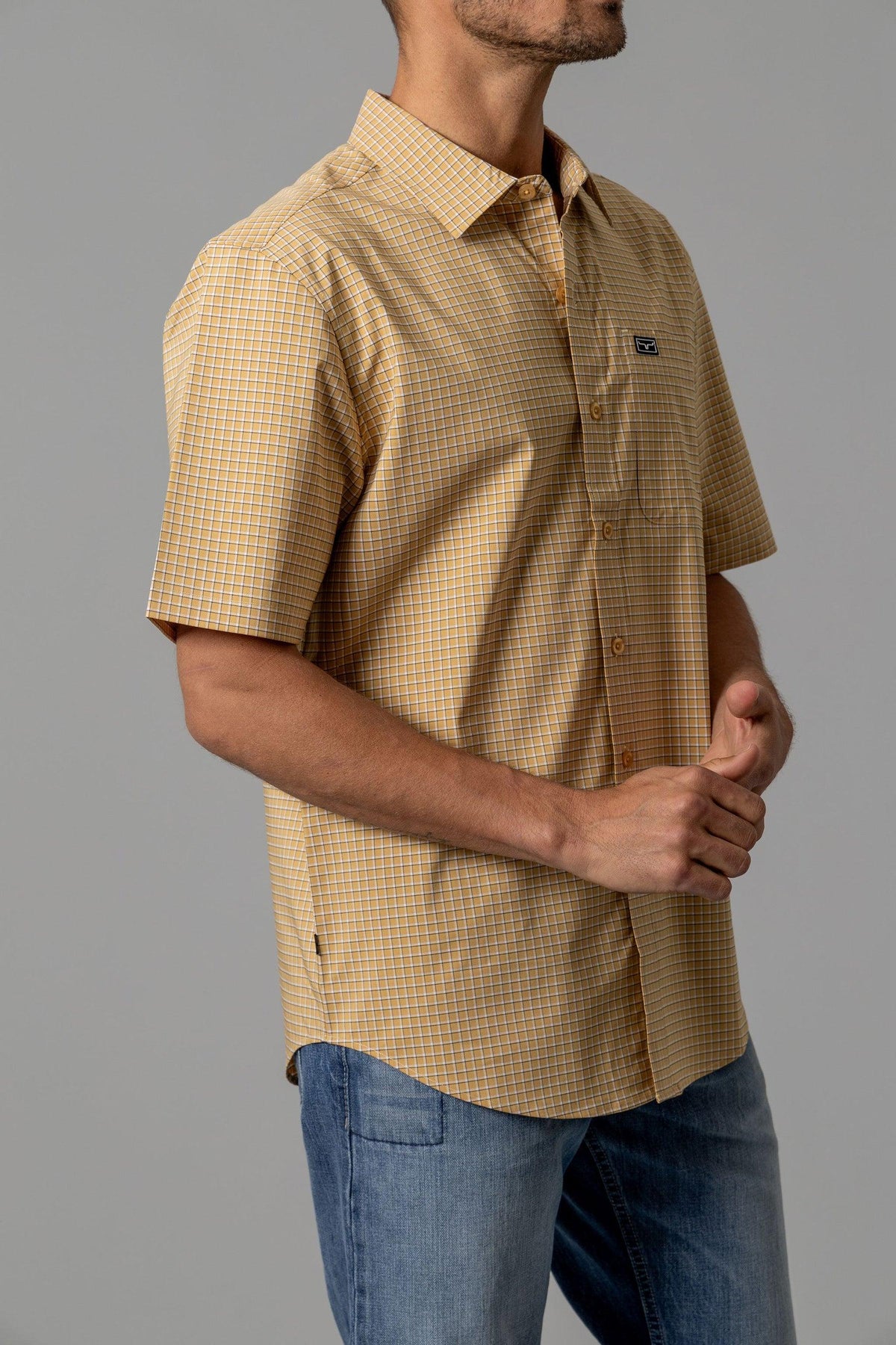 Kimes Ranch MC Cooper short sleeve dress shirt in Gold, side view, with a check pattern and chest pocket