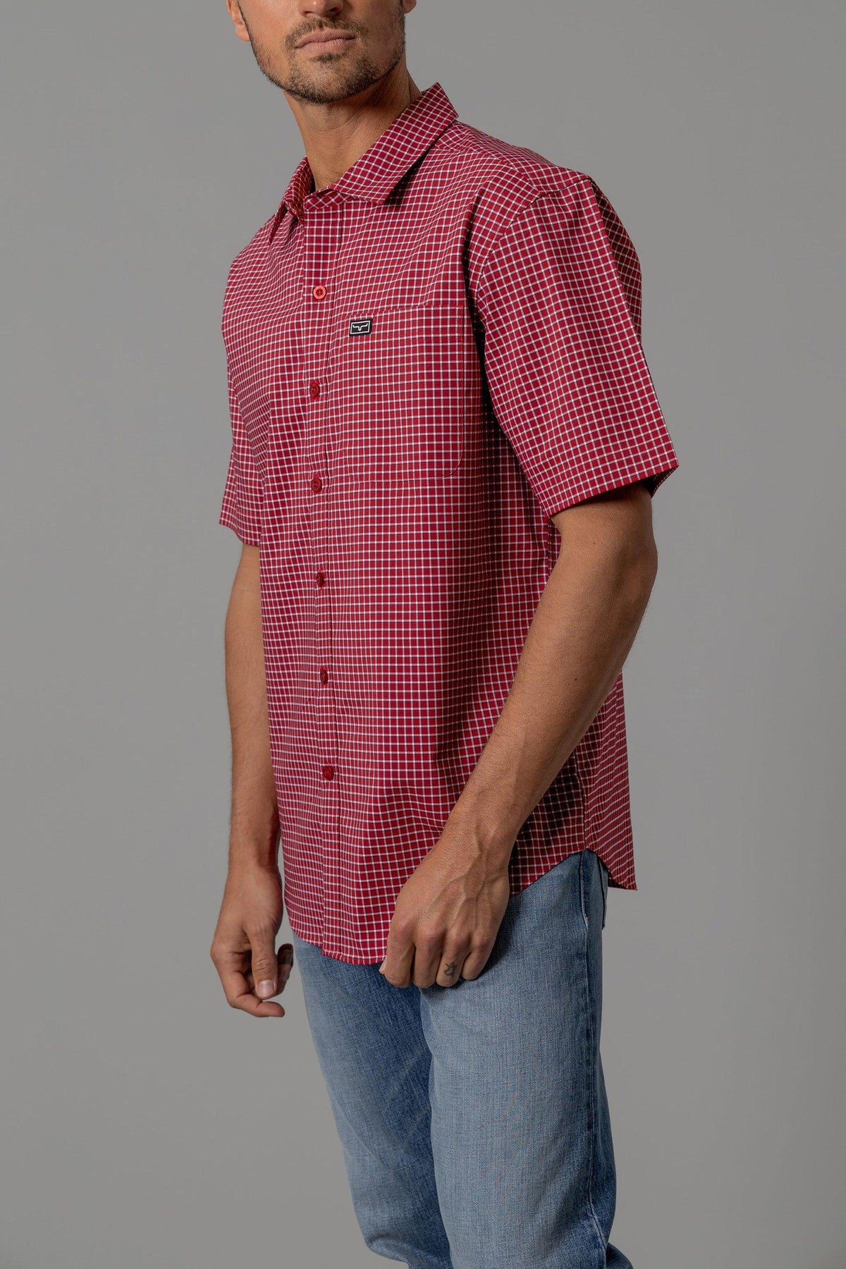Kimes Ranch MC Cooper short sleeve dress shirt in Red, side view, with a white grid pattern and a chest pocket