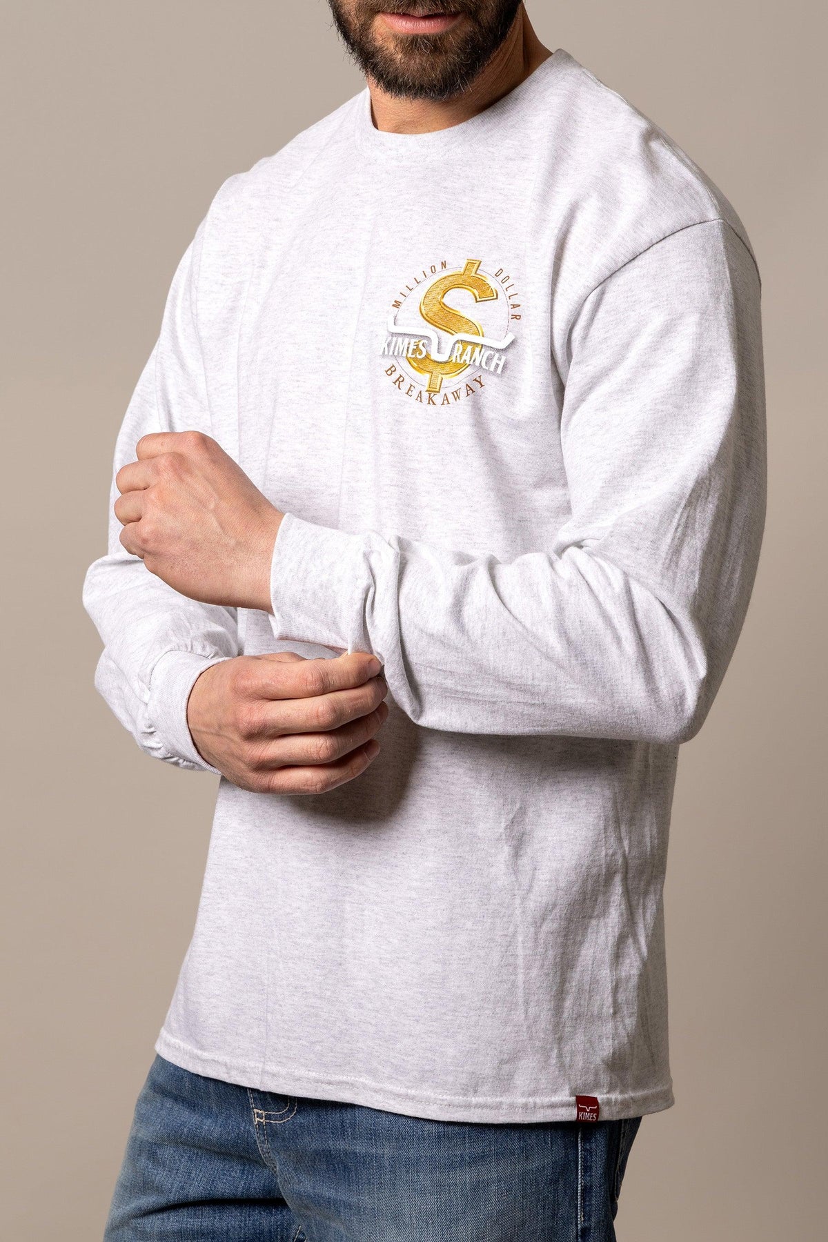 Kimes Ranch MDB Long Sleeve shirt in Ash Heather with a gold dollar sign graphic reading Million Dollar Breakaway