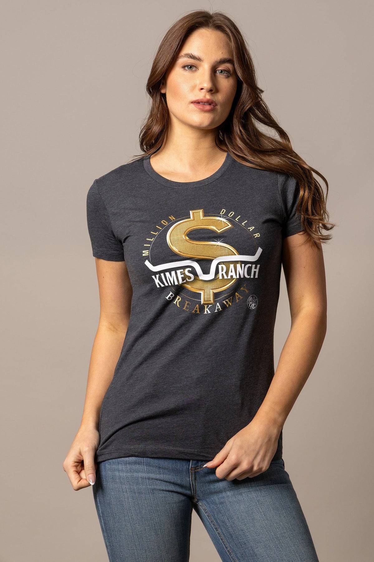 Kimes Ranch Women's MDB Tee in charcoal with a gold dollar sign graphic and text reading Million Dollar Kimes Ranch Breakaway