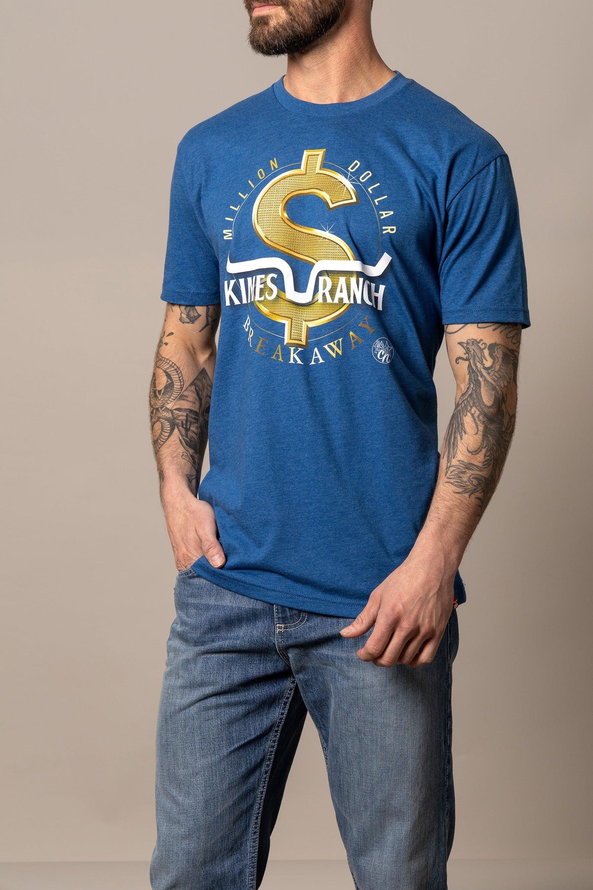 Kimes Ranch Men's MDB Tee in Heather Cool Blue with a gold dollar sign graphic and 'Million Dollar Breakaway' text