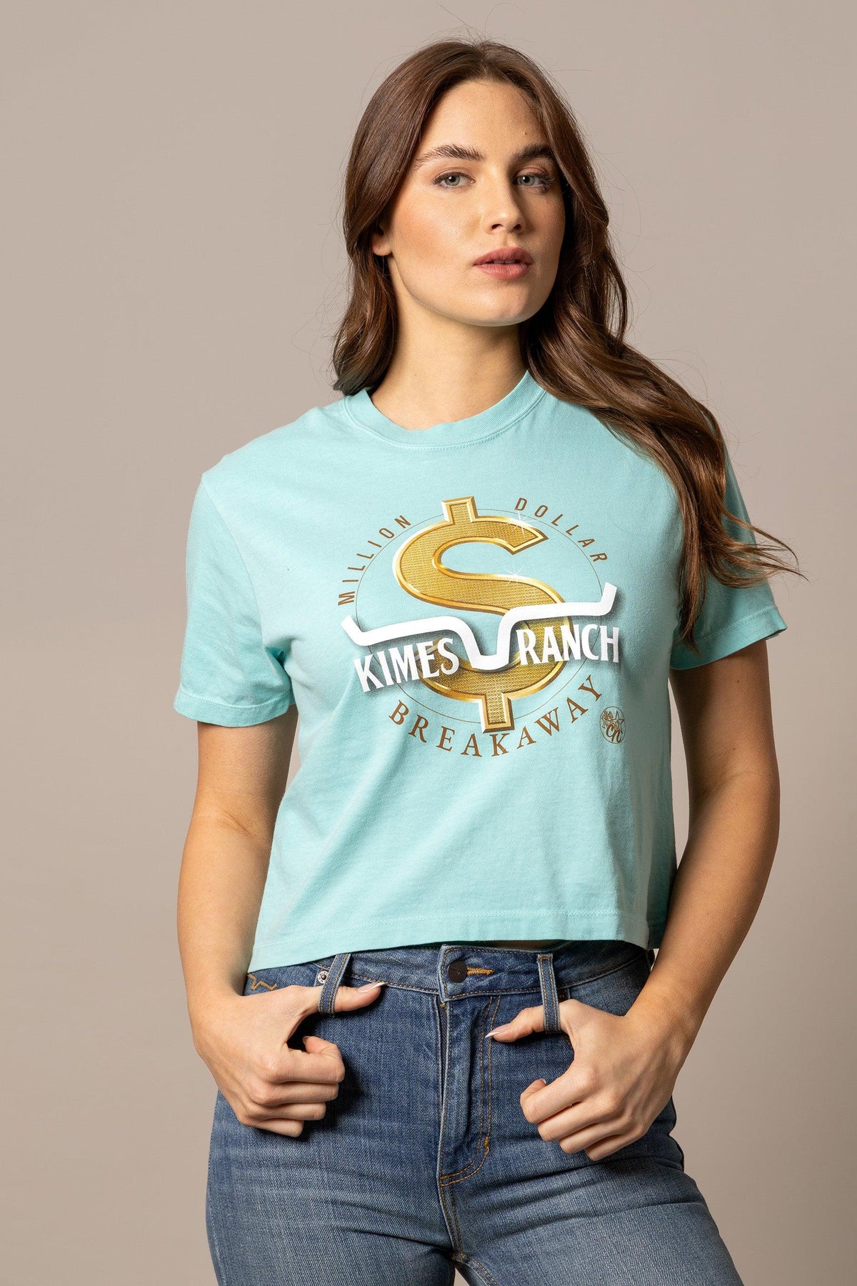Kimes Ranch MDB Women's Crop Tee in mint with a gold dollar sign graphic and 'Million Dollar Breakaway' text