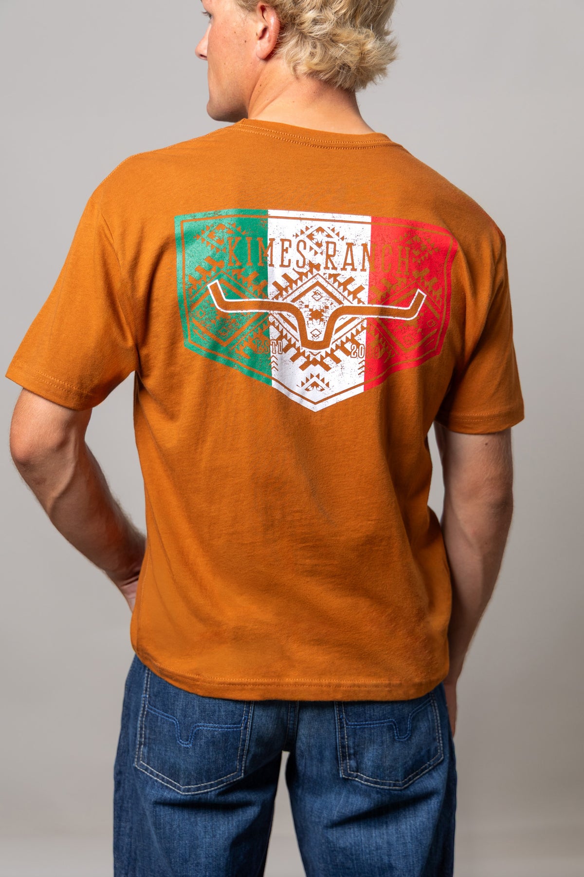 Kimes Ranch Mexicana Plate Shirt in Clay, back view, with a back graphic of the Kimes Ranch logo in green, white, and red