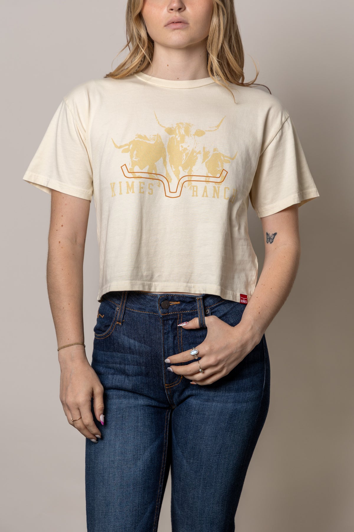 Kimes Ranch Movin' Out shirt in Ivory with a graphic of three longhorns and the brand name