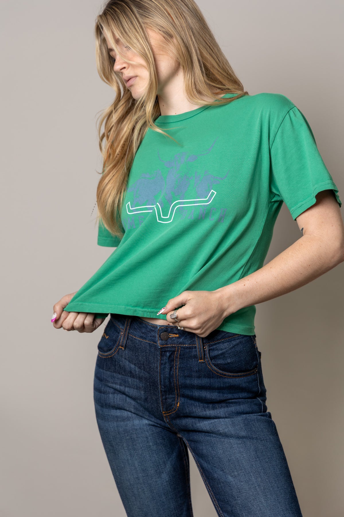 Kimes Ranch Movin' Out shirt in Kelly Green with a graphic of a the Kimes Ranch logo and the brand name
