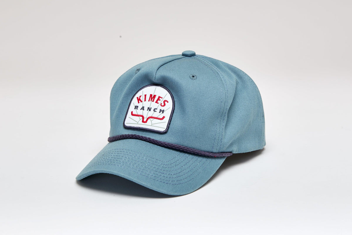 Kimes Ranch Mulligans Hat in Smoke Blue with a front embroidered logo and a dark braided trim on the brim