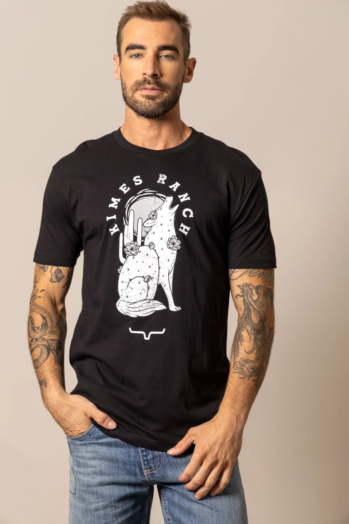 Kimes Ranch Night Call shirt with a white graphic of a howling coyote and cactus with the brand name arched above
