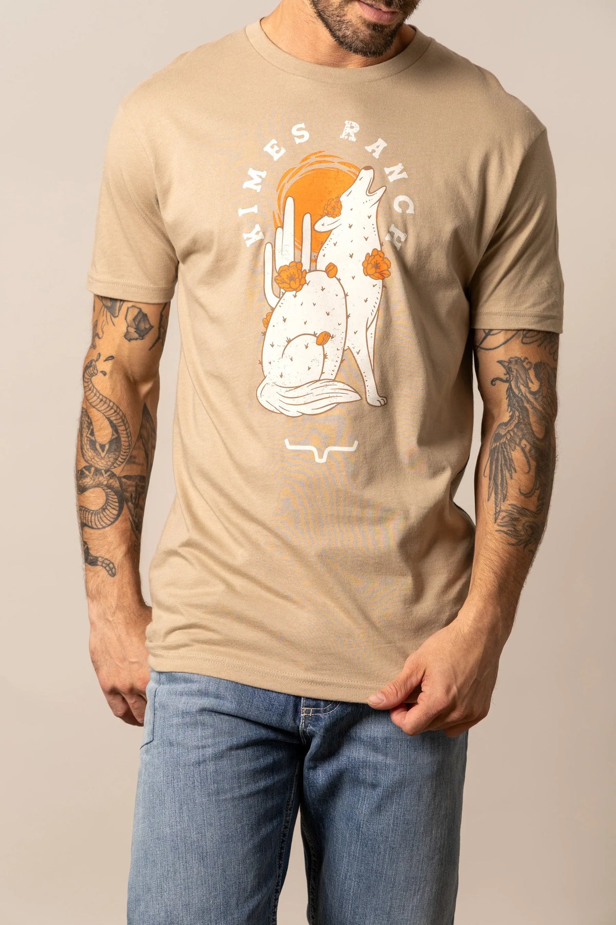 Kimes Ranch Night Call Tan shirt with a howling wolf and cactus graphic with Kimes Ranch logo
