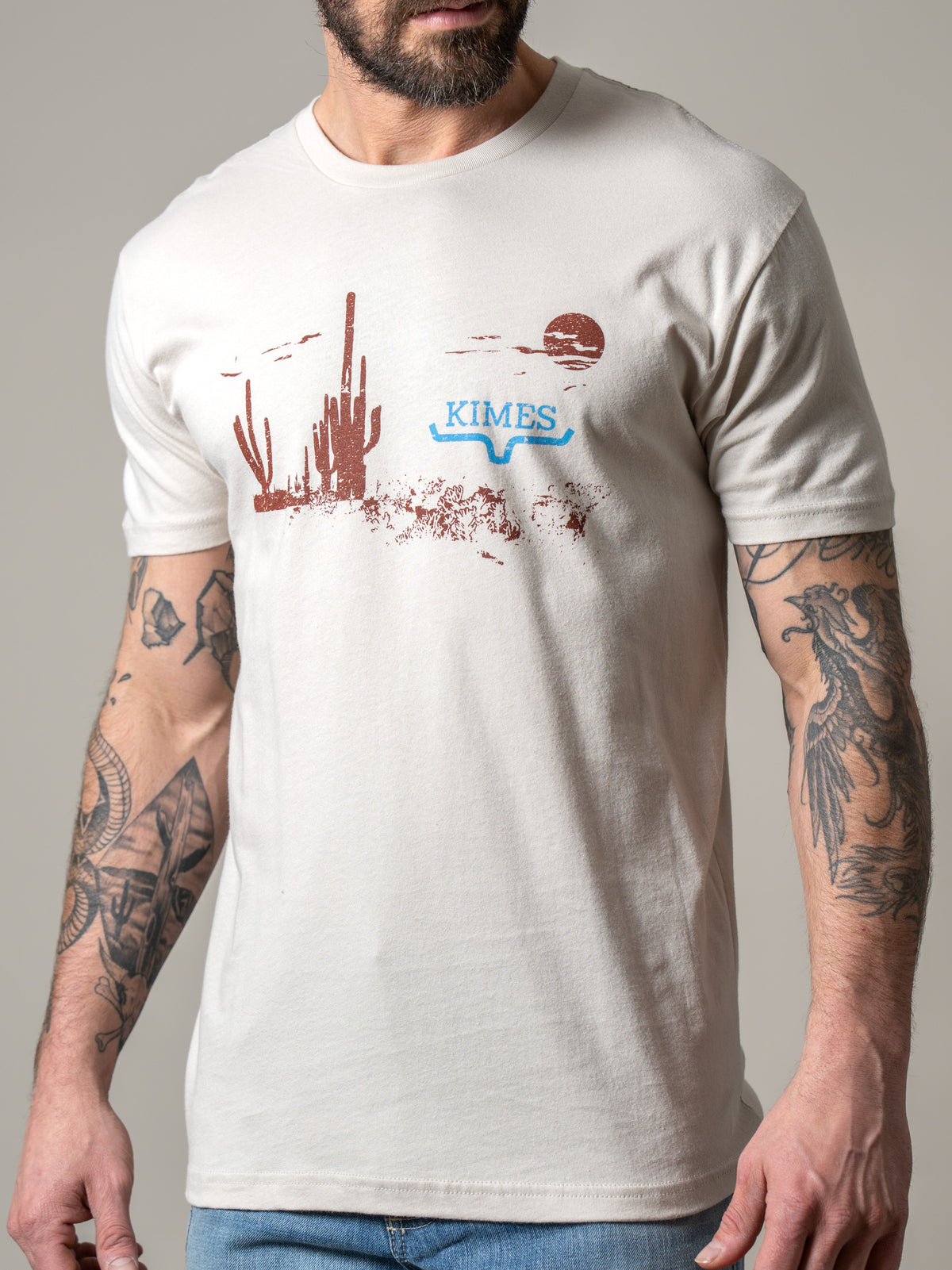 Kimes Ranch Night Fall shirt in Sand with a desert sunset graphic and Kimes Ranch logo