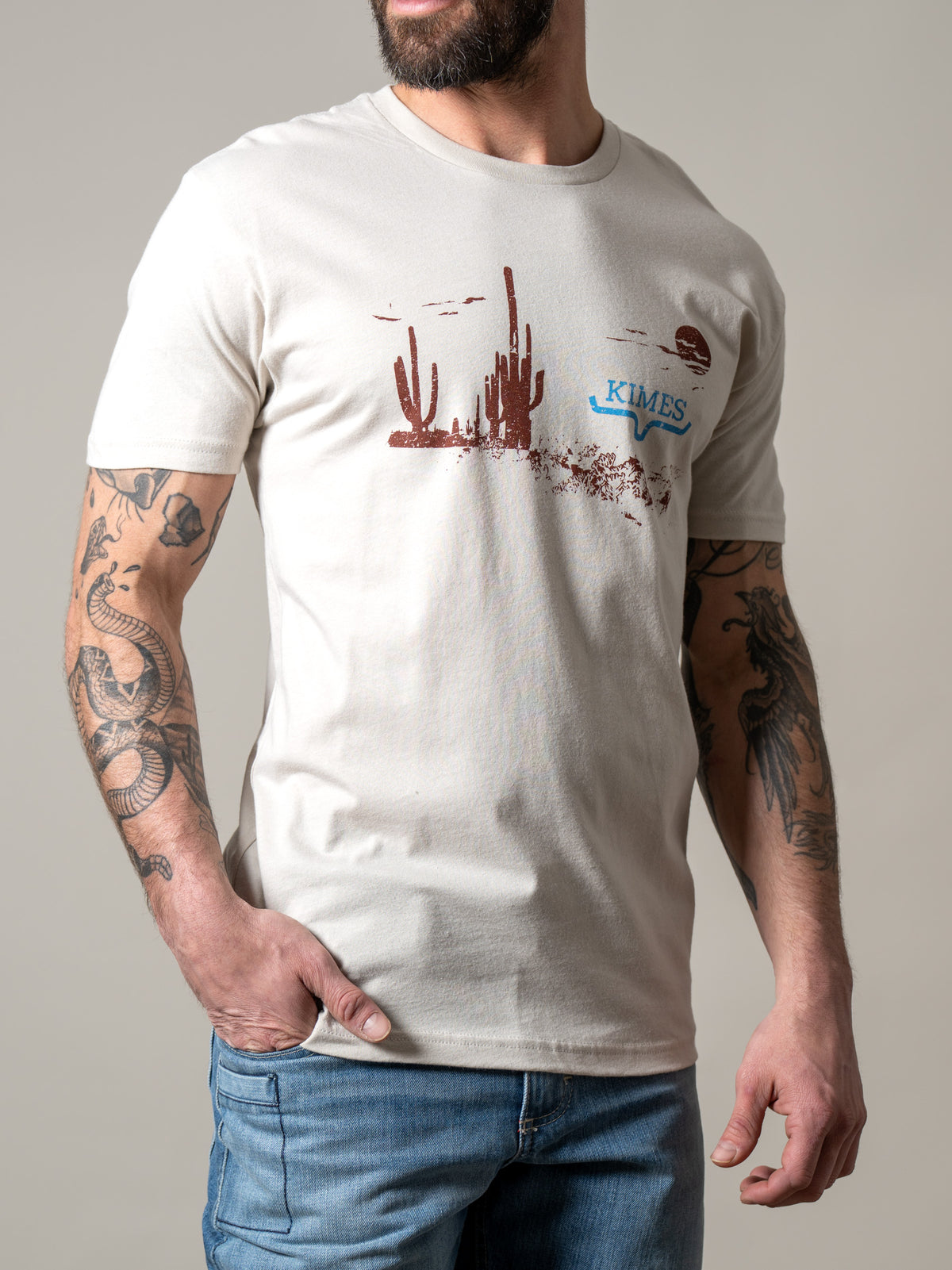 Kimes Ranch Night Fall shirt in Sand with a desert landscape graphic and Kimes Ranch logo