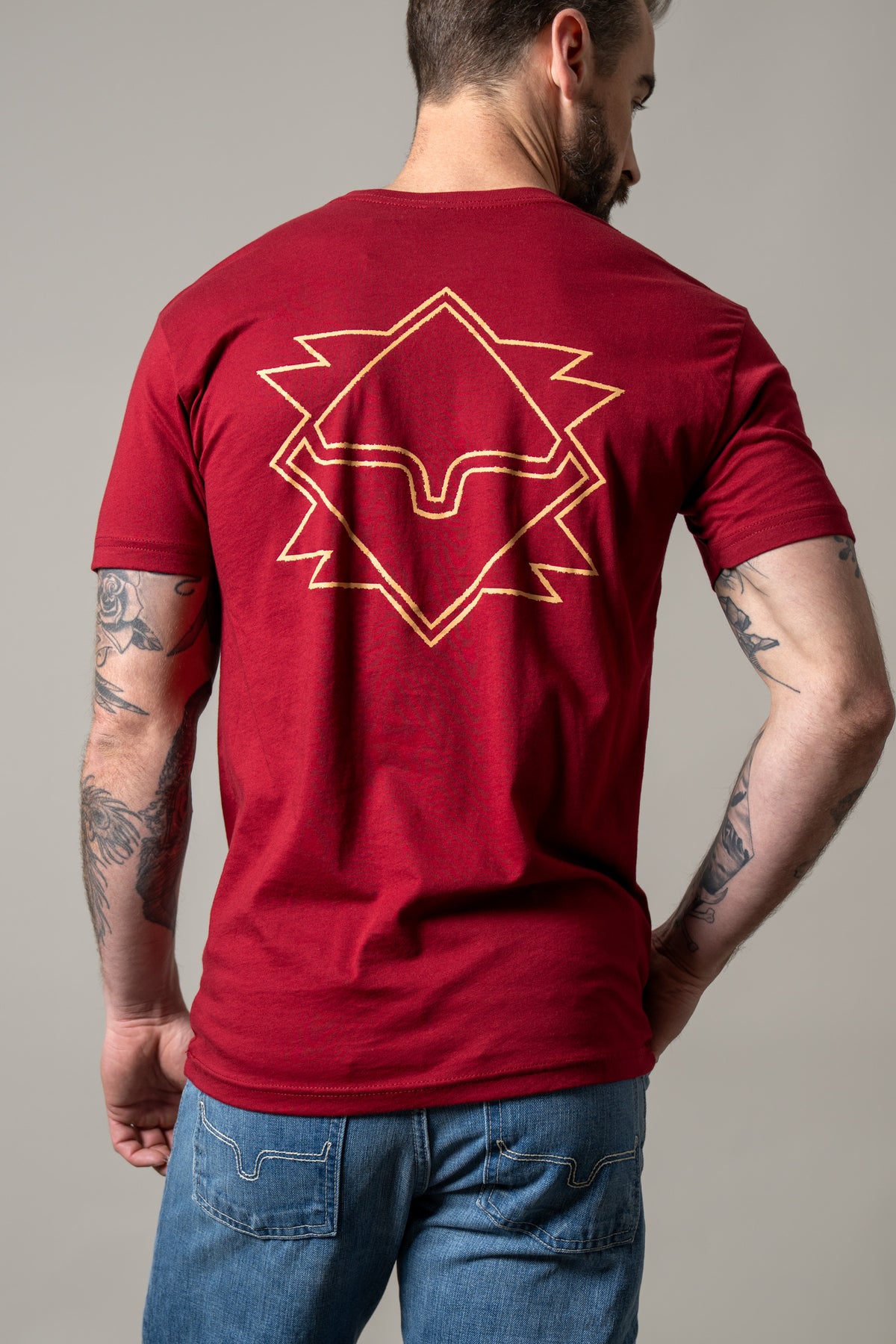 Kimes Ranch North Star shirt in Cardinal, back view, with a large gold geometric star graphic on the back