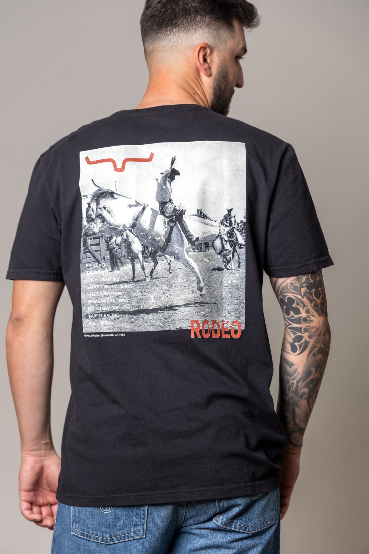 Kimes Ranch Not Our First shirt in Black, back view, with a vintage rodeo graphic and RODEEO text on the back