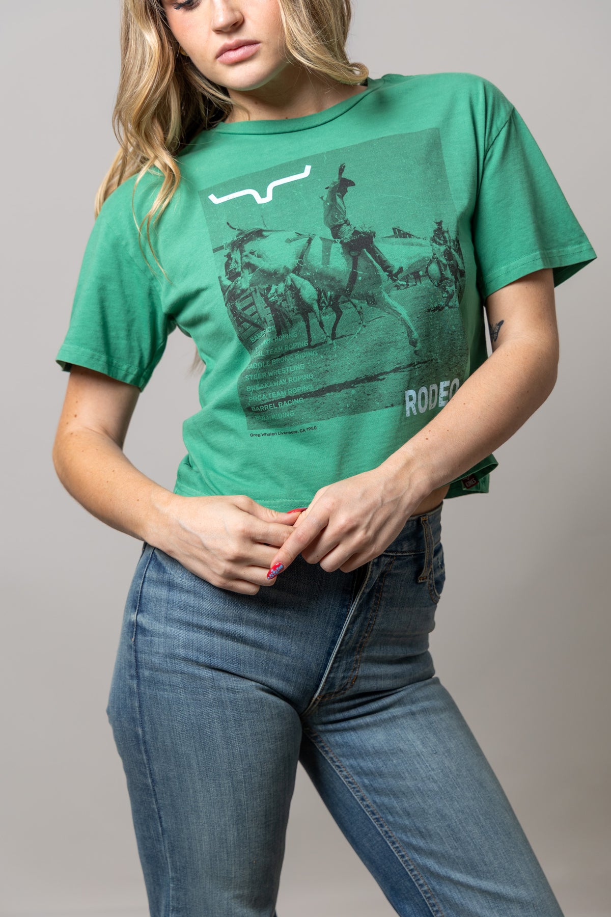 Kimes Ranch Not Our First green short sleeve shirt with a rodeo graphic and RODEO text
