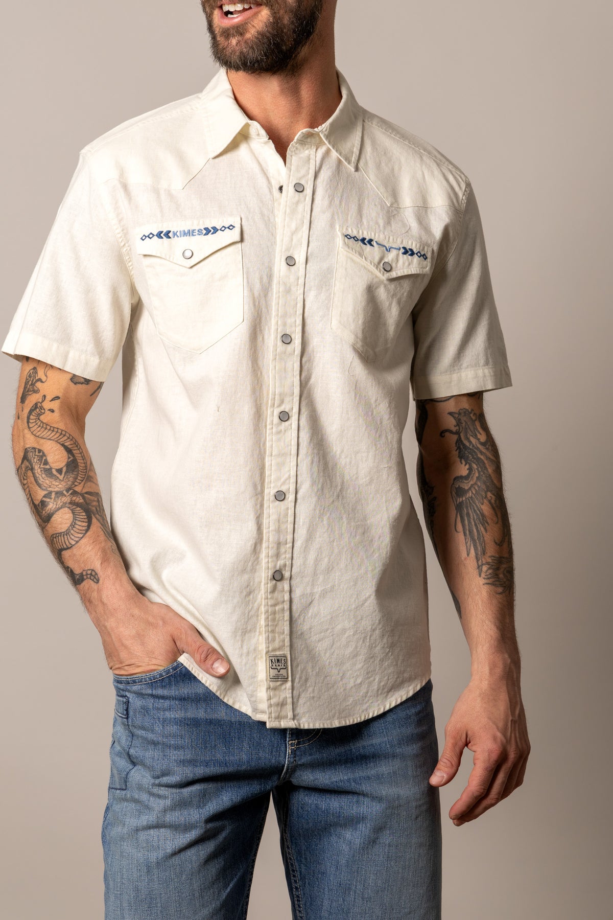 Kimes Ranch Nuce short sleeve dress shirt in Stone with chest pockets and blue embroidery