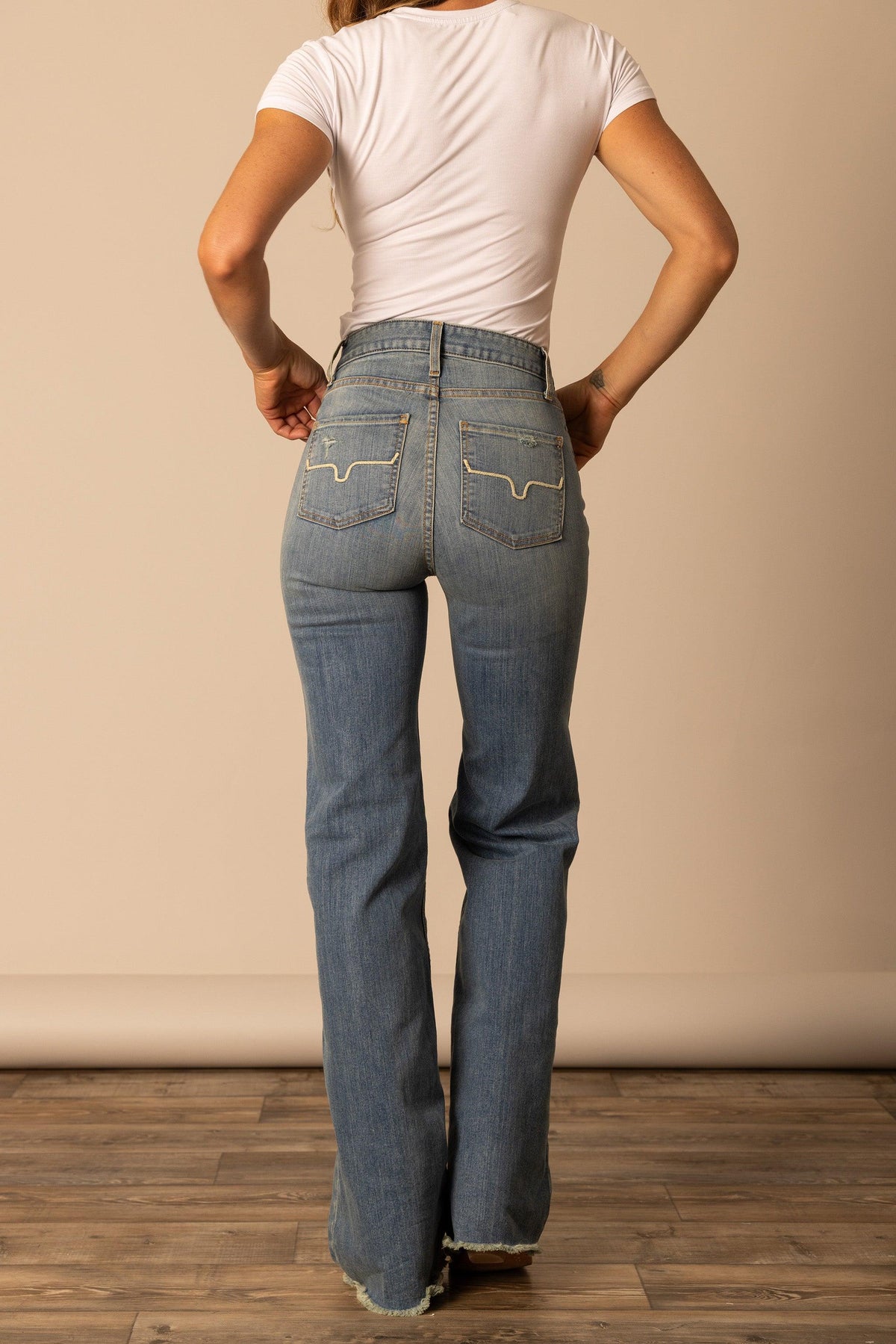 Kimes Ranch Olivia jeans in Light Wash, back view, with signature back pocket stitching and frayed hem