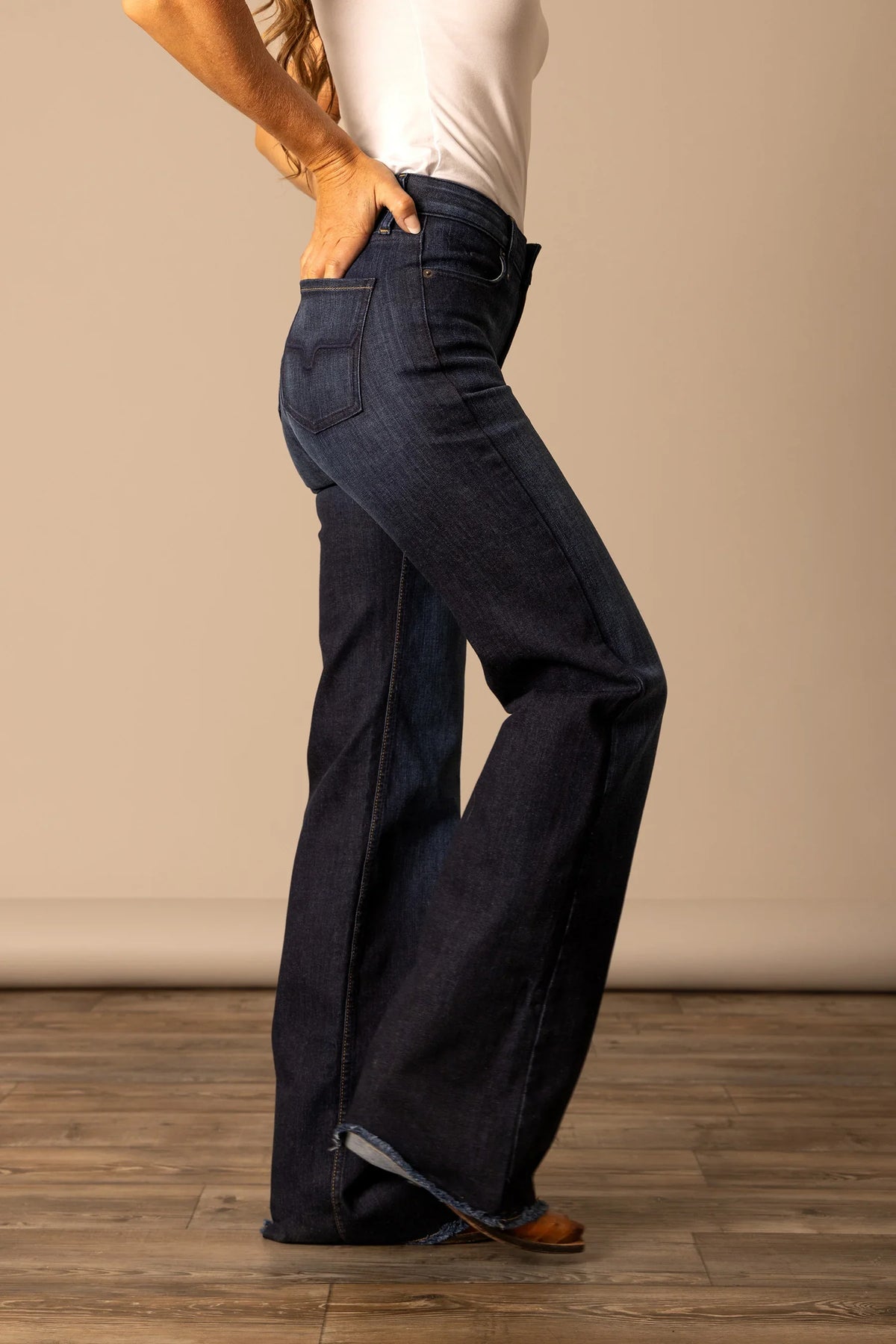 Kimes Ranch Olivia jeans in Dark Wash, side view, with a flared leg and back pocket detail