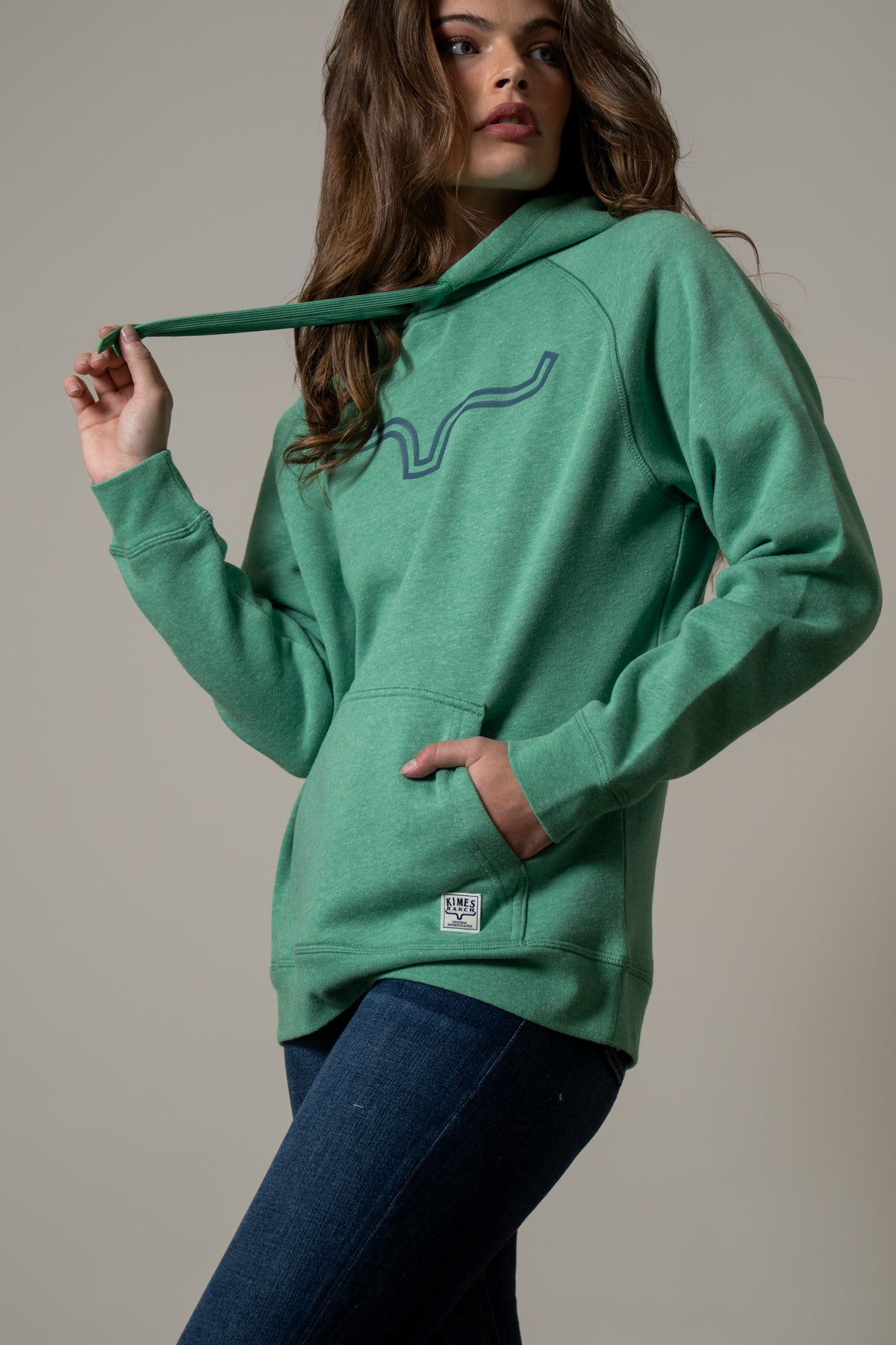 Kimes Ranch Ladies Outlier Hoodie in Kelly Green with a front kangaroo pocket and a Kimes Ranch logo patch