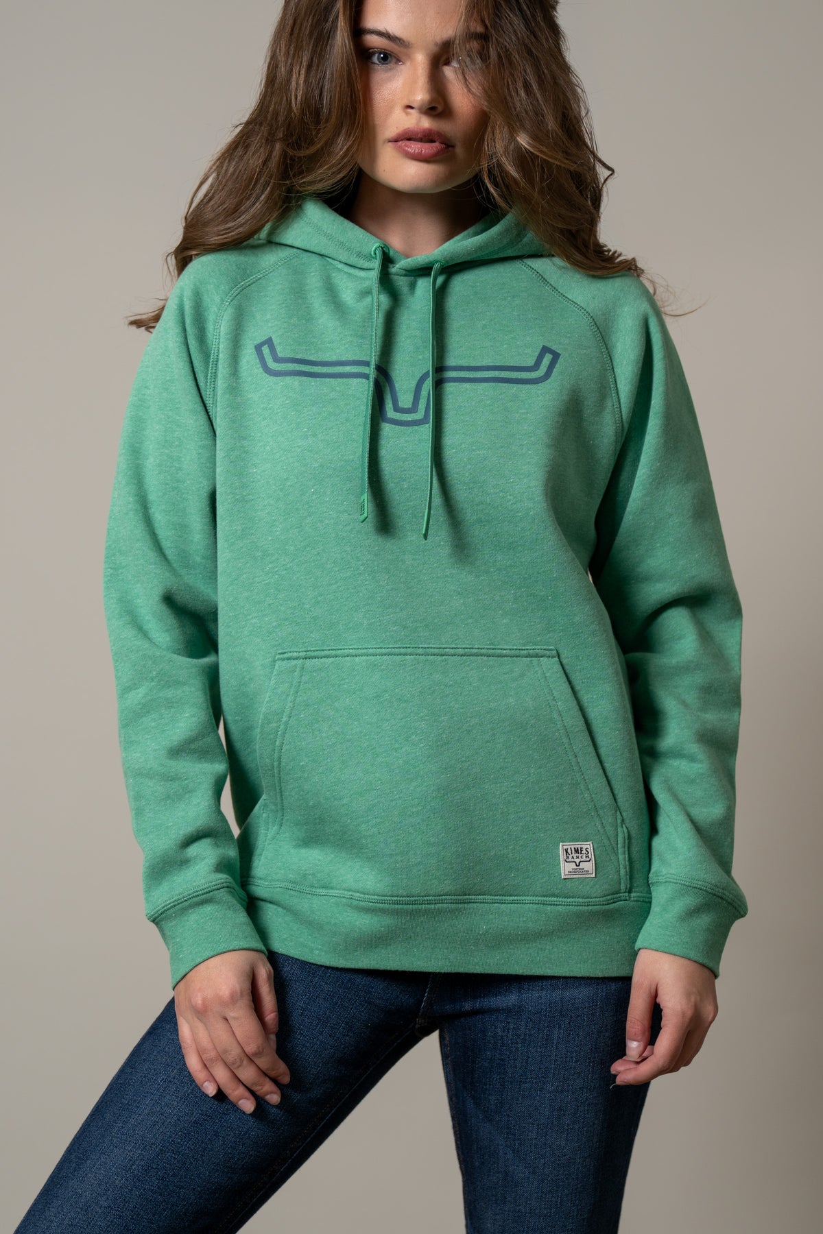 Kimes Ranch Ladies Outlier Hoodie in Kelly Green with a longhorn graphic and front kangaroo pocket