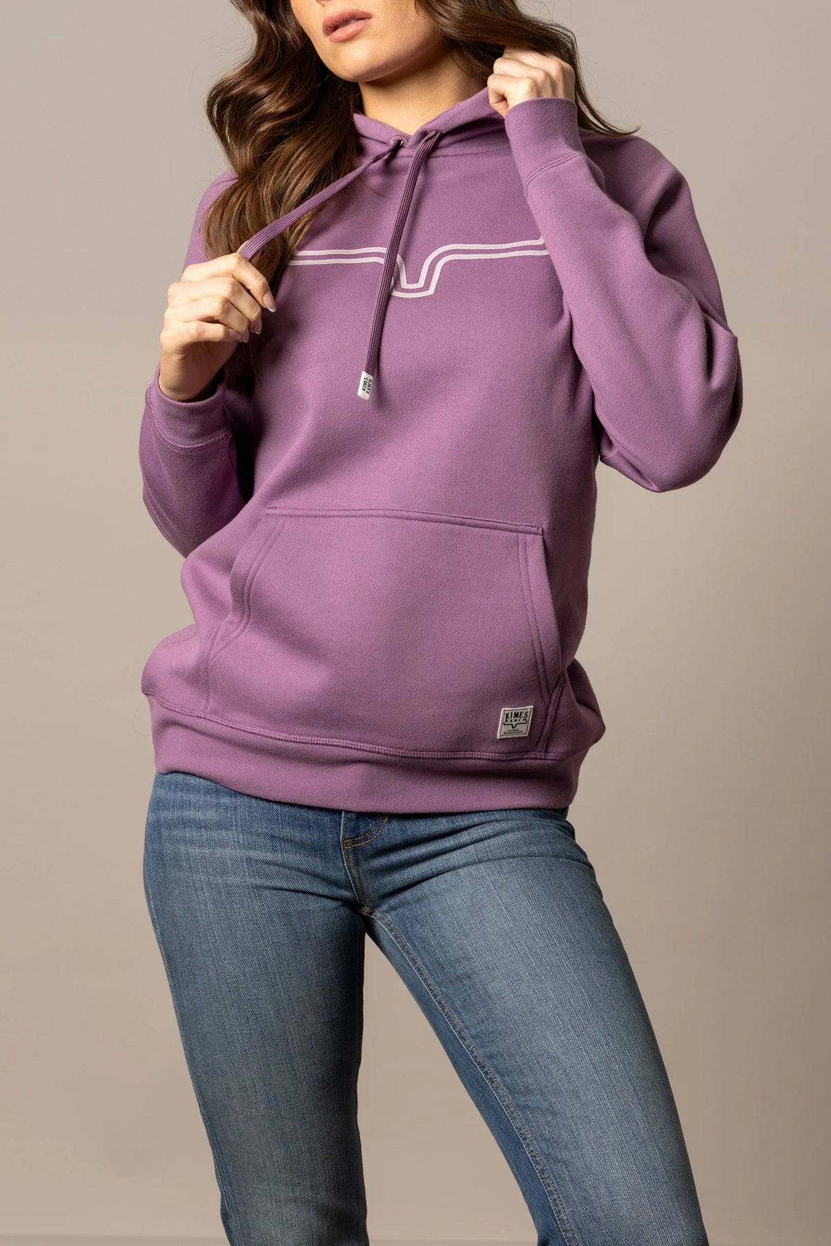 Kimes Ranch Ladies Outlier Hoodie in Lilac with a white graphic on the chest and a front kangaroo pocket