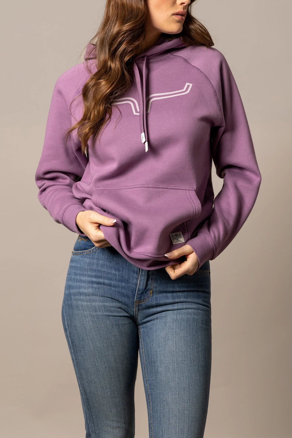 Kimes Ranch Ladies Outlier Hoodie in Lilac with a white graphic on the chest and a front kangaroo pocket