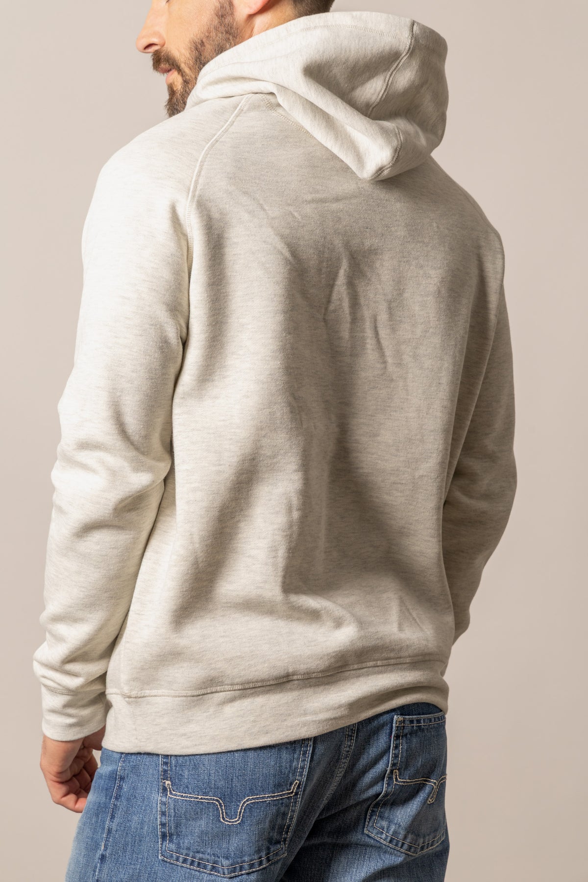 Kimes Ranch Outlier Hoodie in Natural Heather, back view, with the hood and raglan sleeves