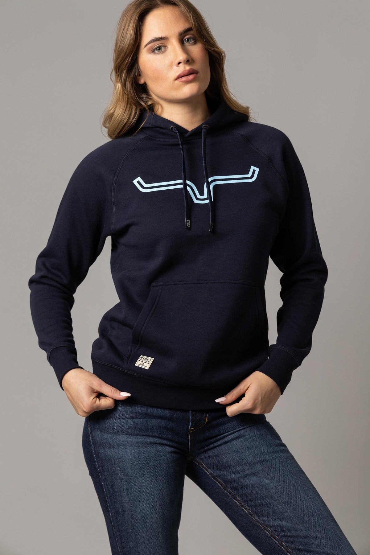 Kimes Ranch Ladies Outlier Hoodie in Navy with a stylized steer logo and front kangaroo pocket