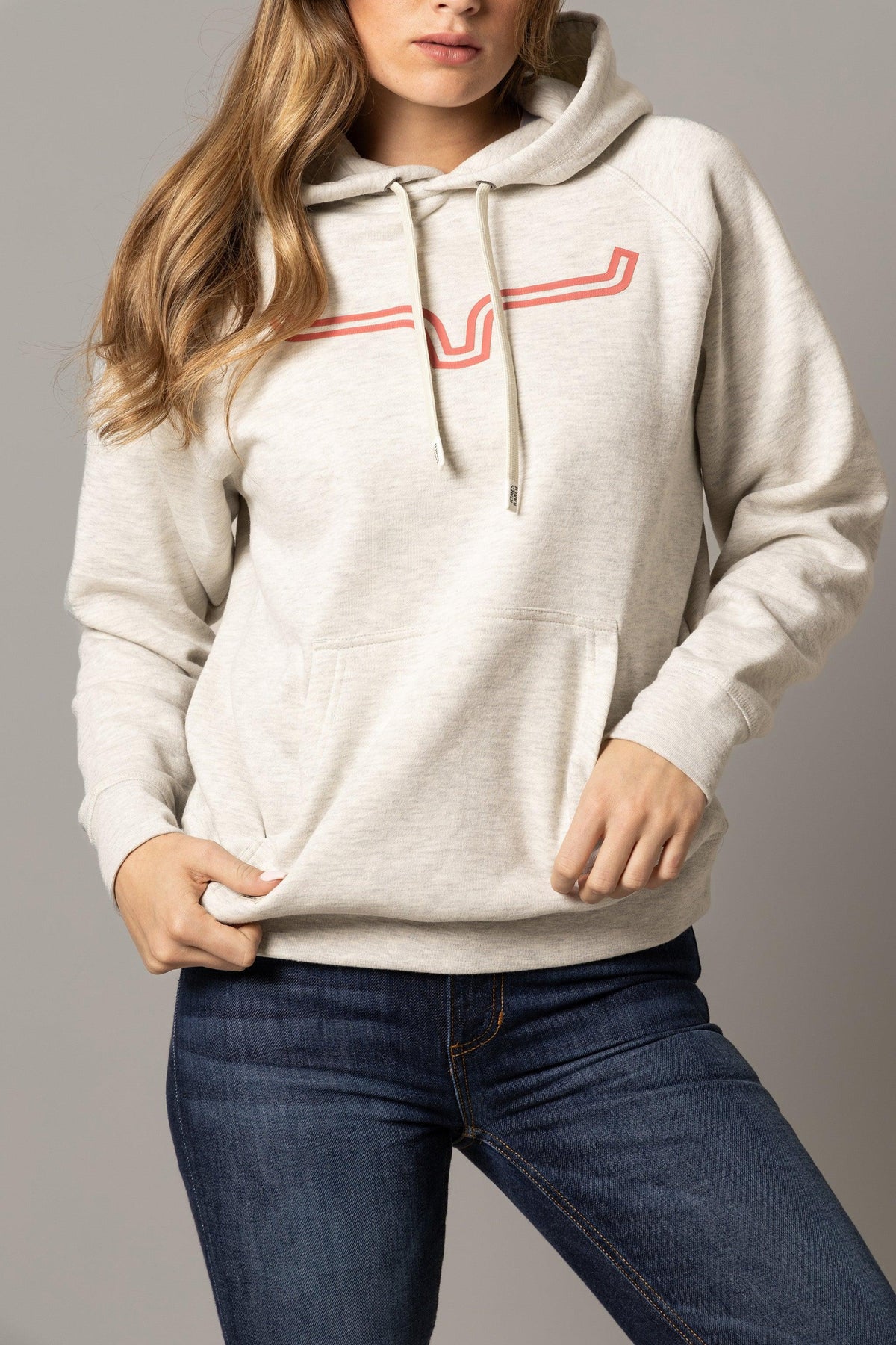 Kimes Ranch Ladies Outlier Hoodie in Oatmeal Heather with a red stylized steer logo and front kangaroo pocket