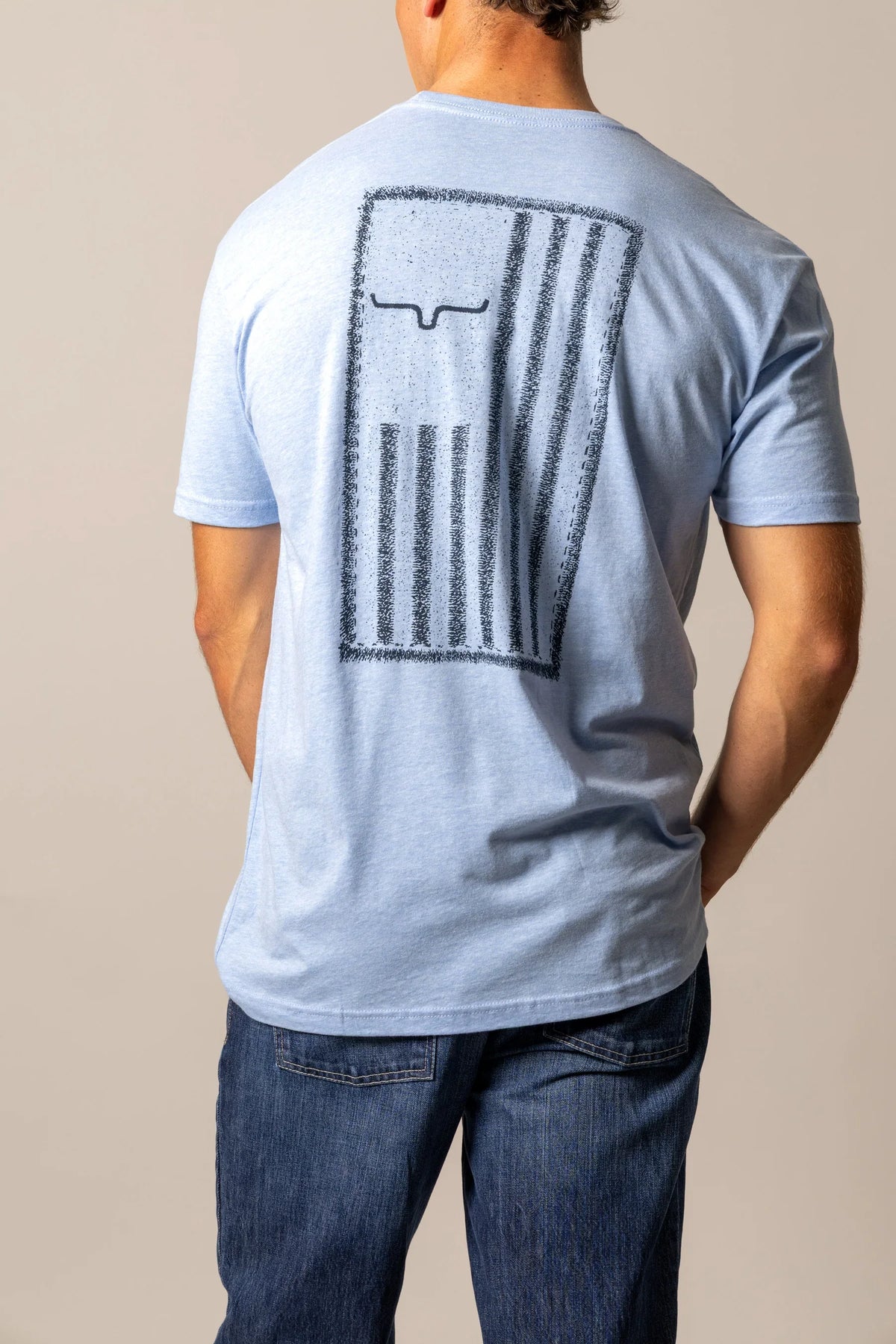 Kimes Ranch Patched shirt in Heather Columbia Blue, back view, with a distressed Kimes Ranch logo on the back